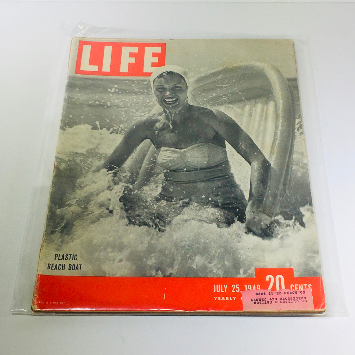 Life Magazine cover from July 25, 1949, featuring a woman enjoying the ocean with a plastic beach boat, highlighting mid-20th century leisure activities.