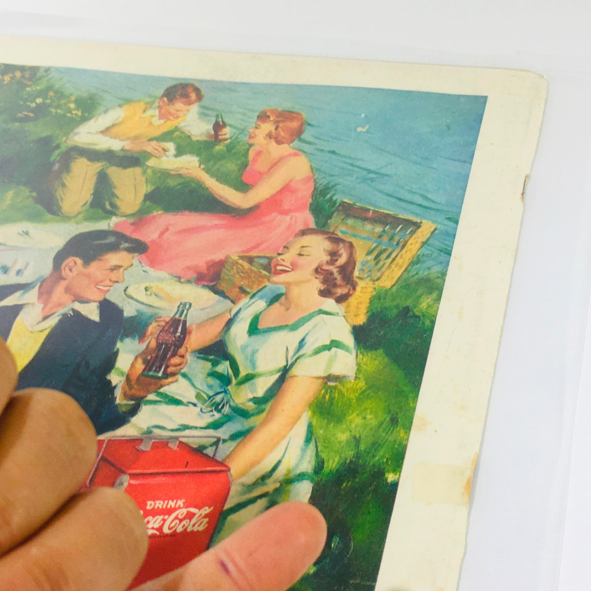 Illustration from Life Magazine, July 25, 1949, depicting a cheerful picnic scene with people enjoying Coca-Cola by the water.