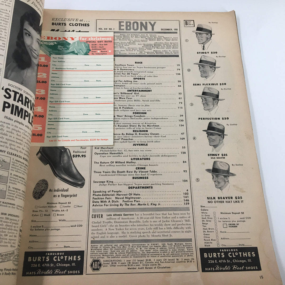 Page from VTG Ebony Magazine December 1958 featuring advertisements including hats from Burt's Clothes and showcasing clothing options, enhancing the nostalgic charm of vintage fashion.