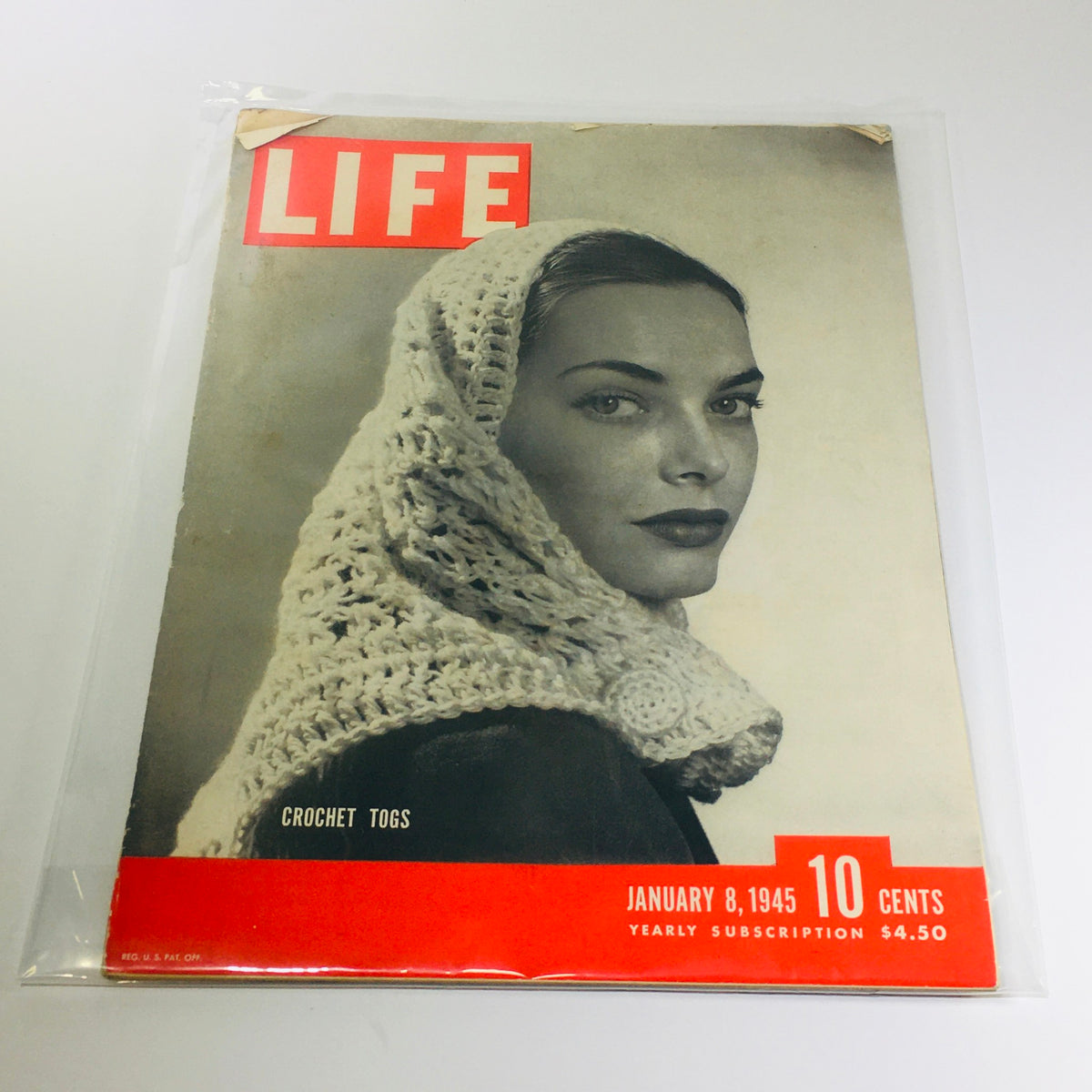 Vintage Life Magazine cover from January 8, 1945, featuring crochet togs and a portrait of a woman wearing a stylish crochet headscarf, capturing fashion trends and wartime culture.