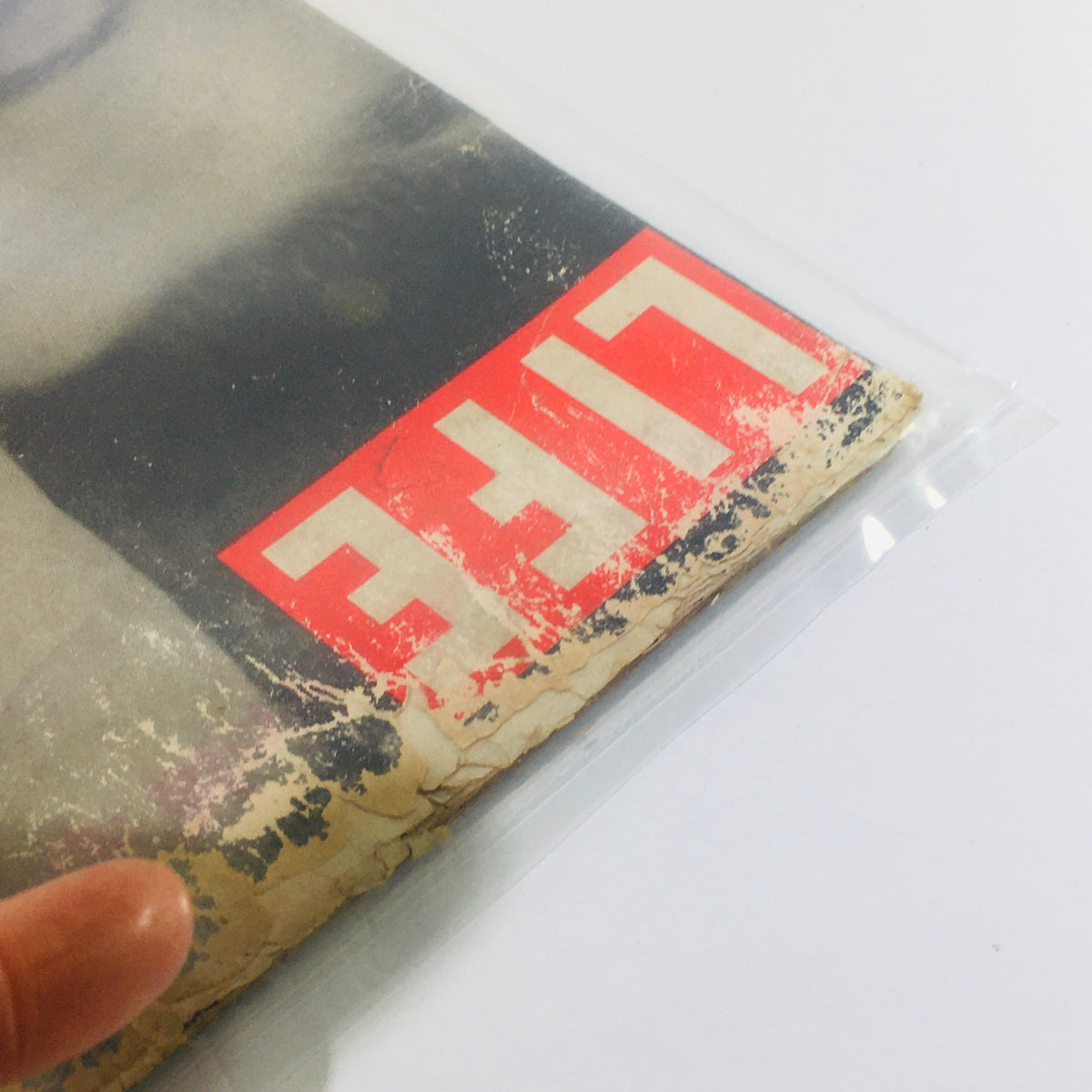 Detailed view of the corner of the Life Magazine December 17, 1951, highlighting the distressed cover with the magazine title 'LIFE' in bold letters, capturing the vintage essence.
