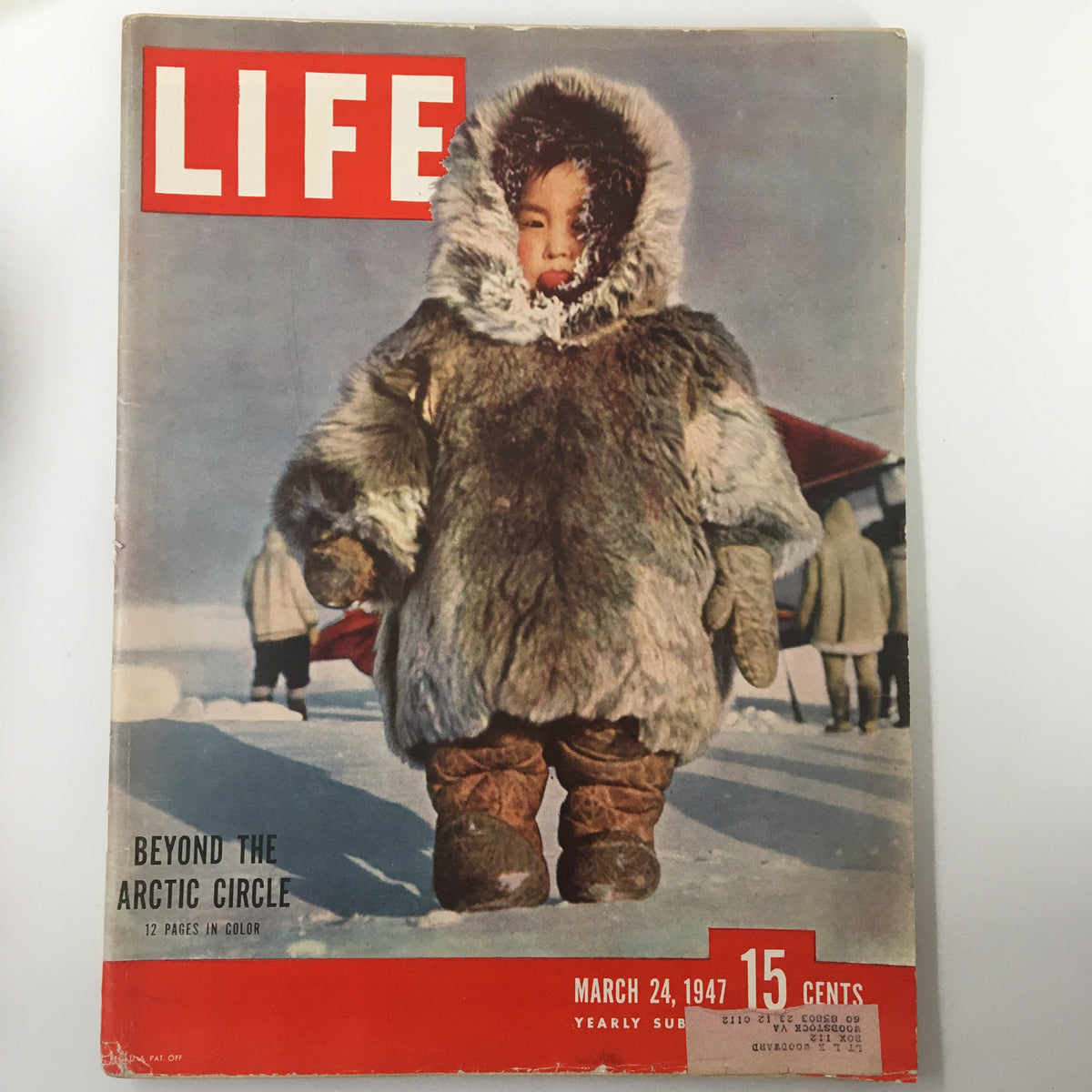 Vintage cover of Life Magazine dated March 24, 1947, showcasing a child in a fur coat standing in the snowy Arctic landscape, highlighting the theme 'Beyond The Arctic Circle in Color'.