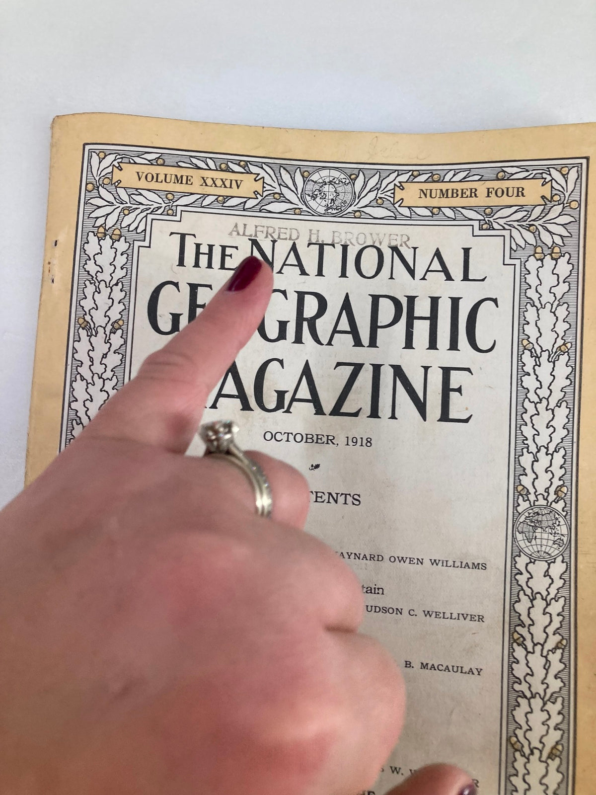 Close-up of VTG The National Geographic Magazine October 1918 cover with a hand holding it to show details.