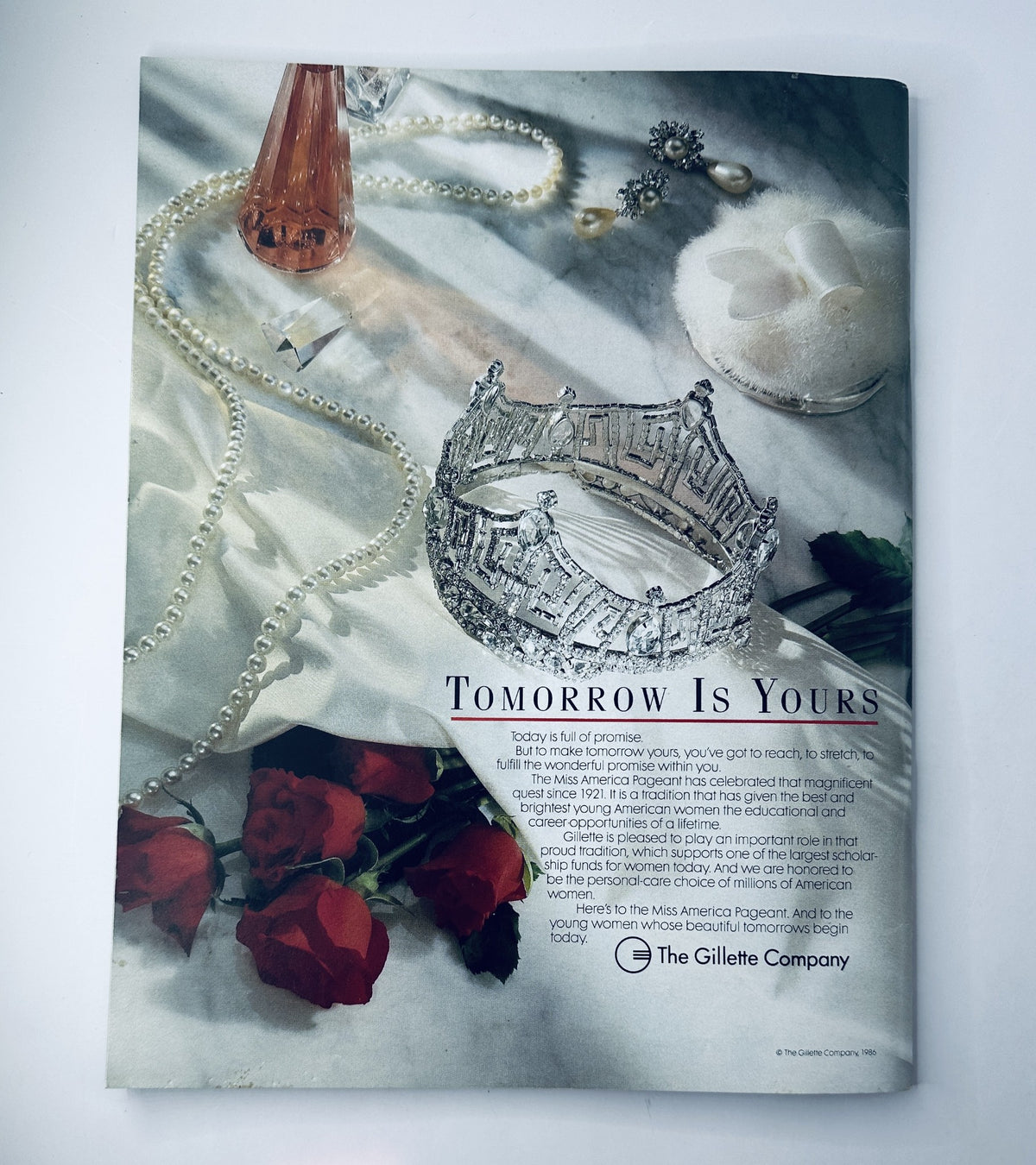 Back cover of The 1987 Miss America Pageant Magazine, displaying a promotional image with a crown, roses, and a note about the pageant's significance, aligning with its official theme.
