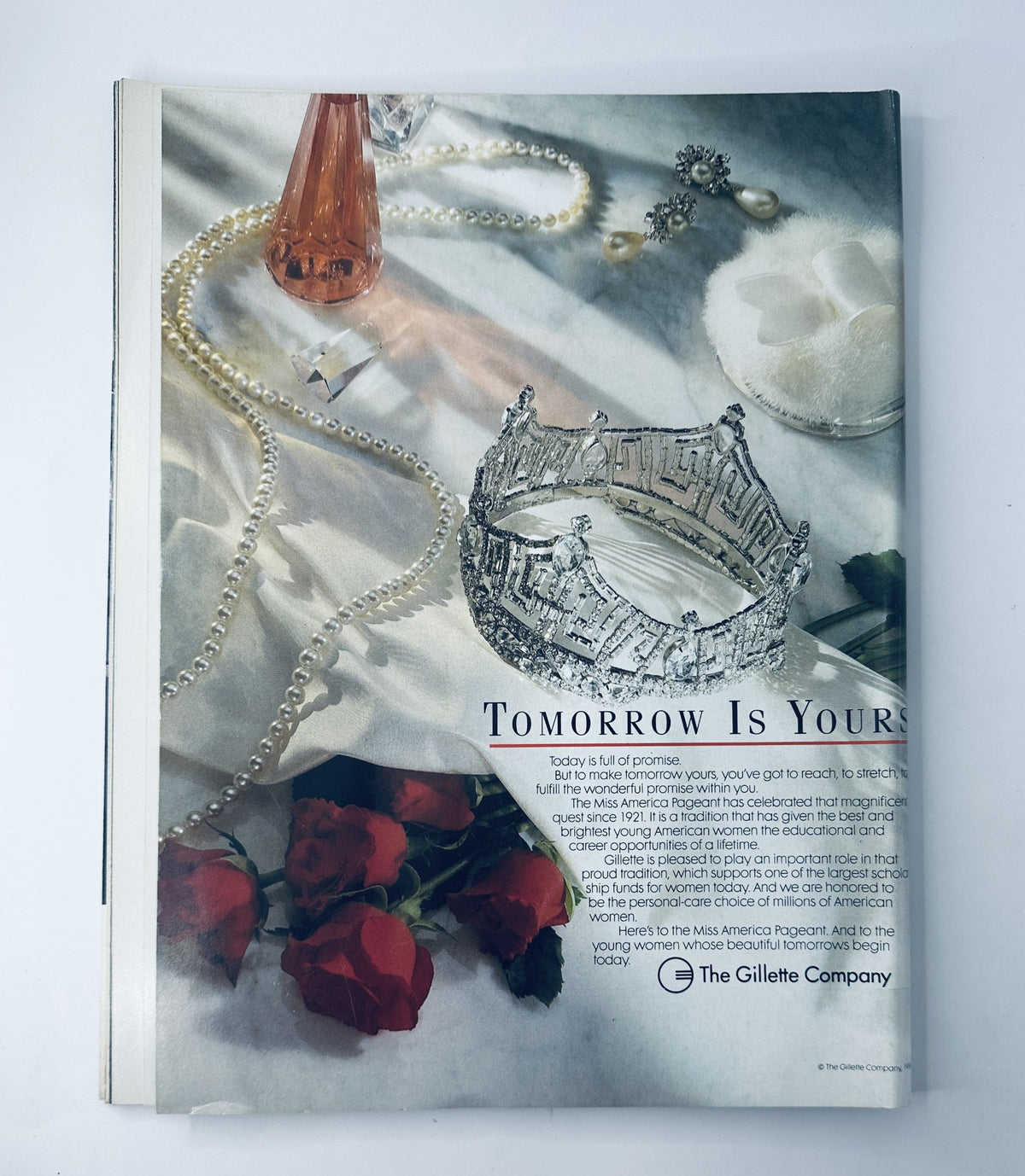 1988 Miss America Pageant Magazine Program advertisement titled 'Tomorrow Is Yours', showcasing luxurious items such as a crown, pearls, and roses, promoting the significance of the Miss America Pageant in empowering women.