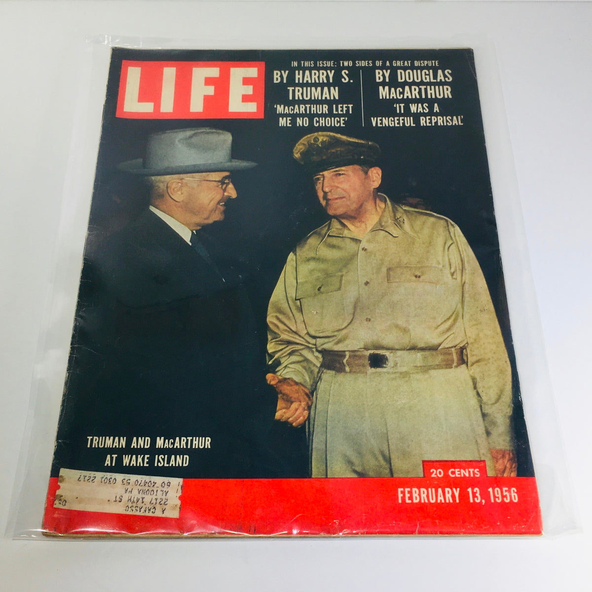 Vintage Life Magazine from February 13, 1956, featuring Harry Truman and Douglas MacArthur at Wake Island on the cover. This magazine captures a significant moment in American history with a depiction of these two renowned leaders.