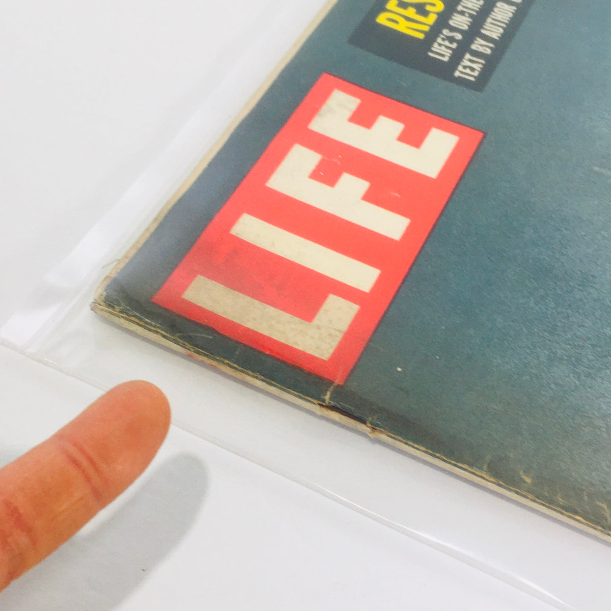Side view of the Vintage Life Magazine from August 6, 1956, displaying the iconic 'LIFE' logo and the magazine's age-related wear, emphasizing its historical significance.