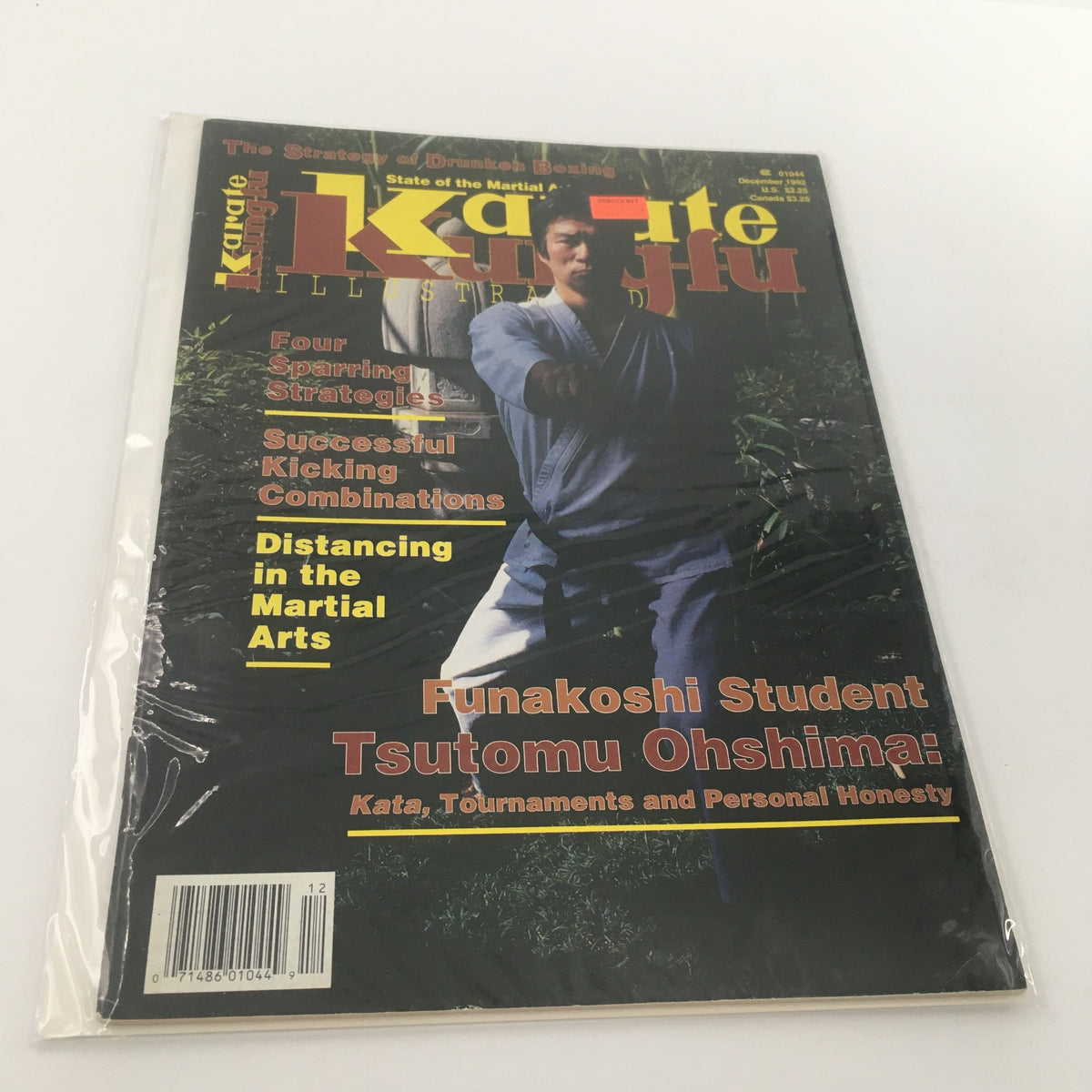 Cover of the December 1992 issue of Karate Kung Fu Illustrated featuring Tsutomu Oshima, showcasing kata techniques, sparring strategies, and martial arts reflections. Magazine is in excellent condition, bagged and boarded with a price sticker.