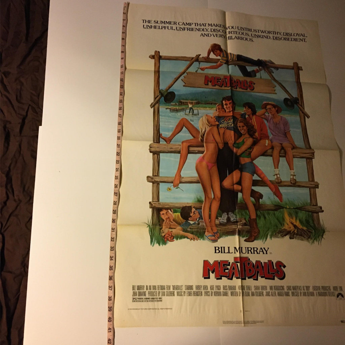 Detailed view of the 1979 MeatBalls Original Movie Poster, featuring Bill Murray, highlighting the poster's size and vibrant camp scene.