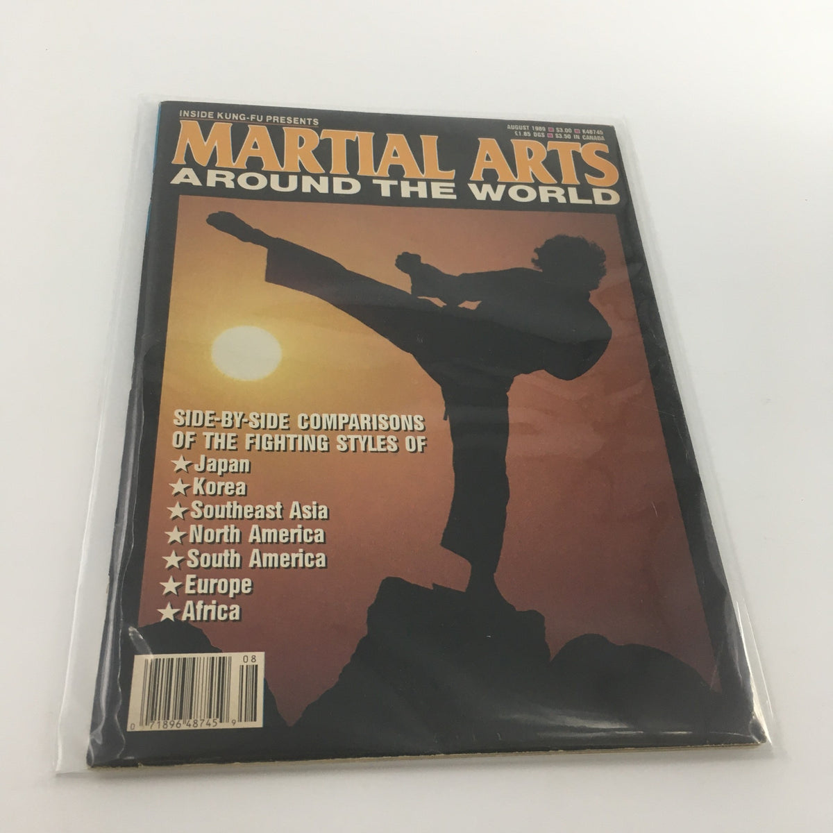 Martial Arts Around The World August 1989 magazine cover featuring a martial artist performing a high kick against a sunset backdrop, highlighting the fighting styles from various regions including Japan, Korea, Southeast Asia, North America, South America, Europe, and Africa.