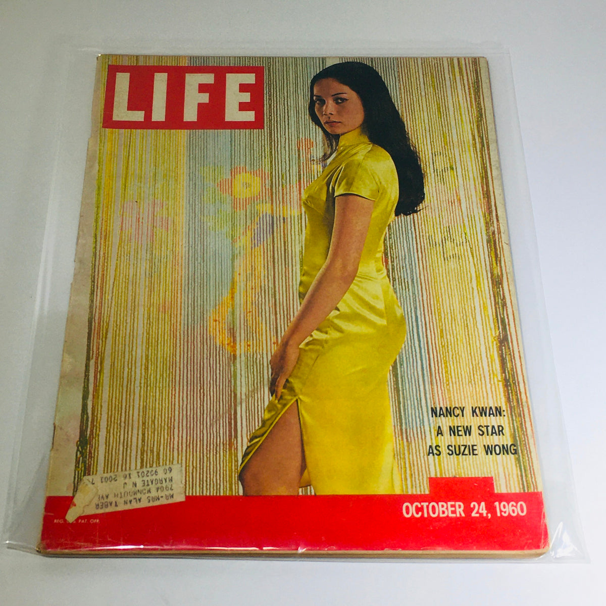 VTG Life Magazine: October 24, 1960 featuring Nancy Kwan in a stunning yellow dress, showcasing her as a new star in 'Suzie Wong'.