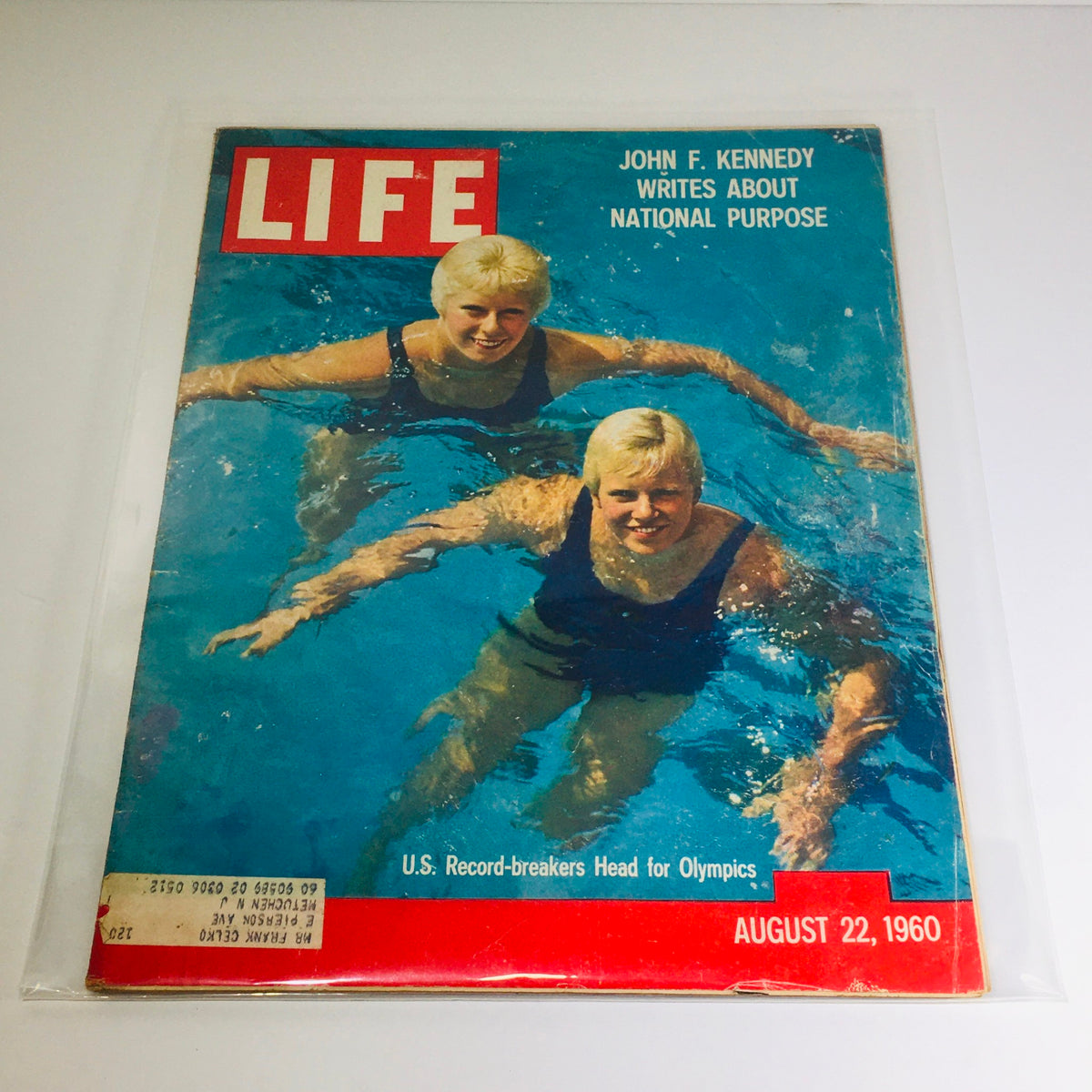 Vintage Life Magazine from August 22, 1960 featuring John F. Kennedy's article on National Purpose, showcasing two swimmers on the cover amidst a blue swimming pool backdrop.