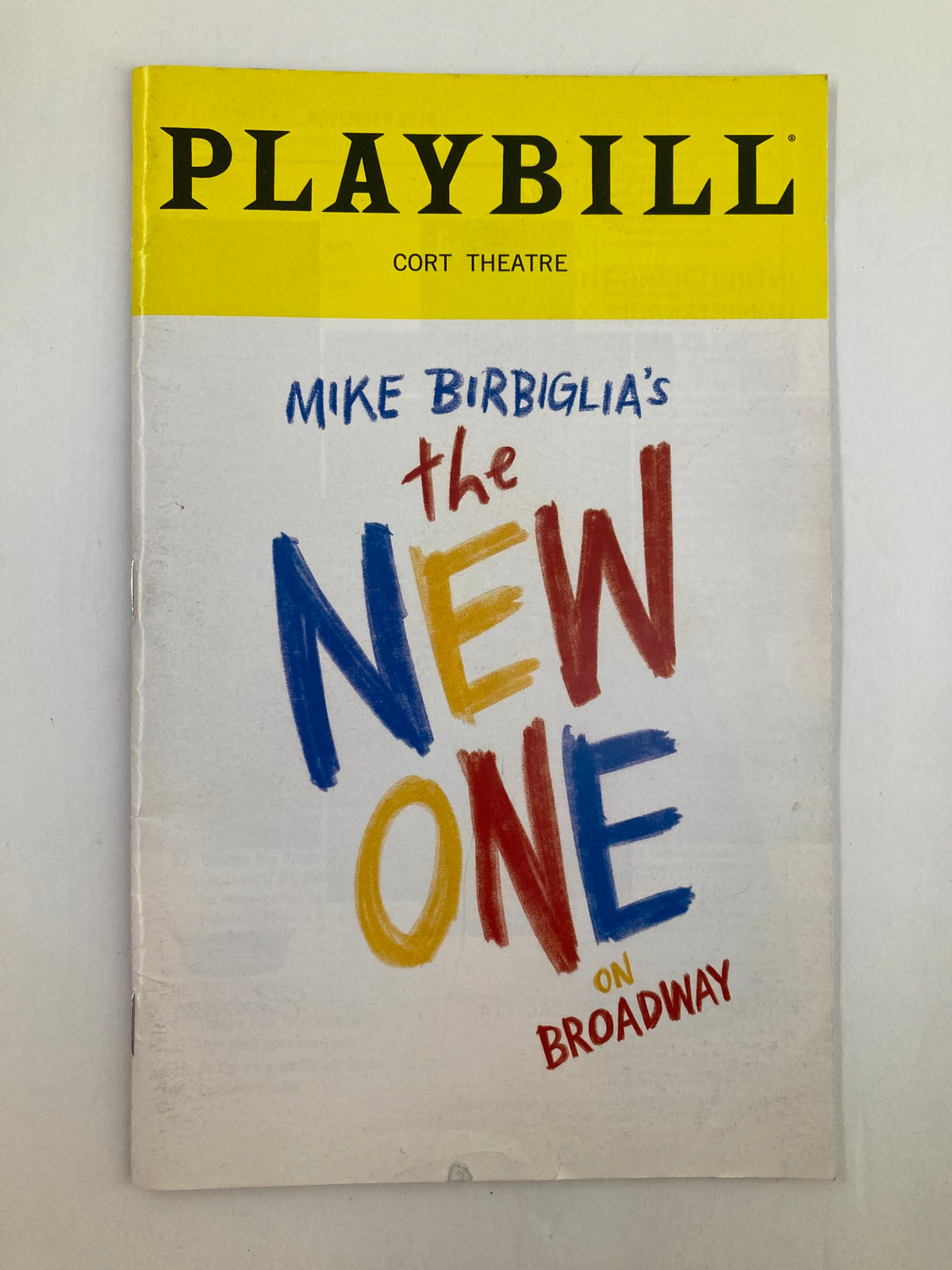 Cover of the 2018 Playbill from Cort Theatre featuring Mike Birbiglia's The New One, showcasing colorful artwork and bold typography.