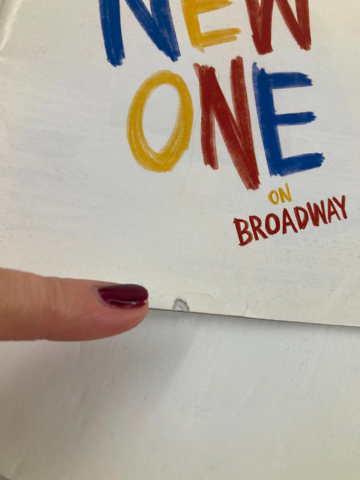 Close-up of the 2018 Playbill from Cort Theatre for Mike Birbiglia's The New One, showing minor rip details on the edge.