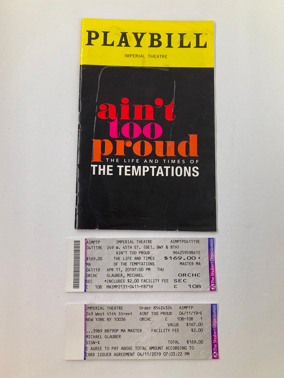 2019 Playbill from the Imperial Theatre featuring Ain't Too Proud showcasing Derrick Baskin and James Harkness, accompanied by tickets from the show.