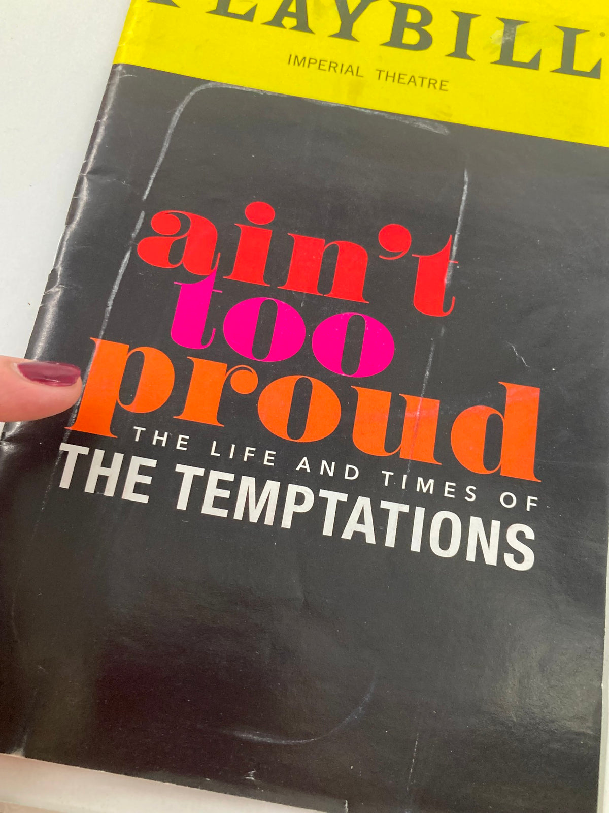 Close-up of the cover of the 2019 Playbill for 'Ain't Too Proud', highlighting its title and design, representing the life and times of the Temptations.
