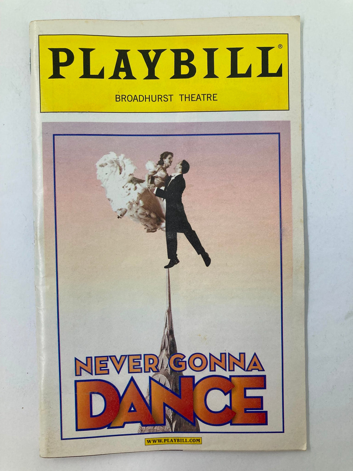 2003 Playbill for Johnny Mercer in Never Gonna Dance featuring vintage cover art with a dancer and vibrant backdrop from the Broadhurst Theatre.