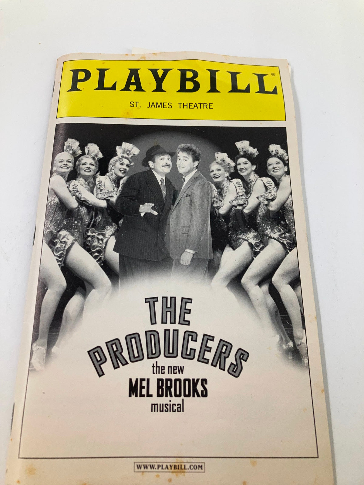 Close-up of the 2003 Playbill from St. James Theatre for The Producers, highlighting Lewis J. Stadlen and vibrant cast member visuals from Mel Brooks' show.