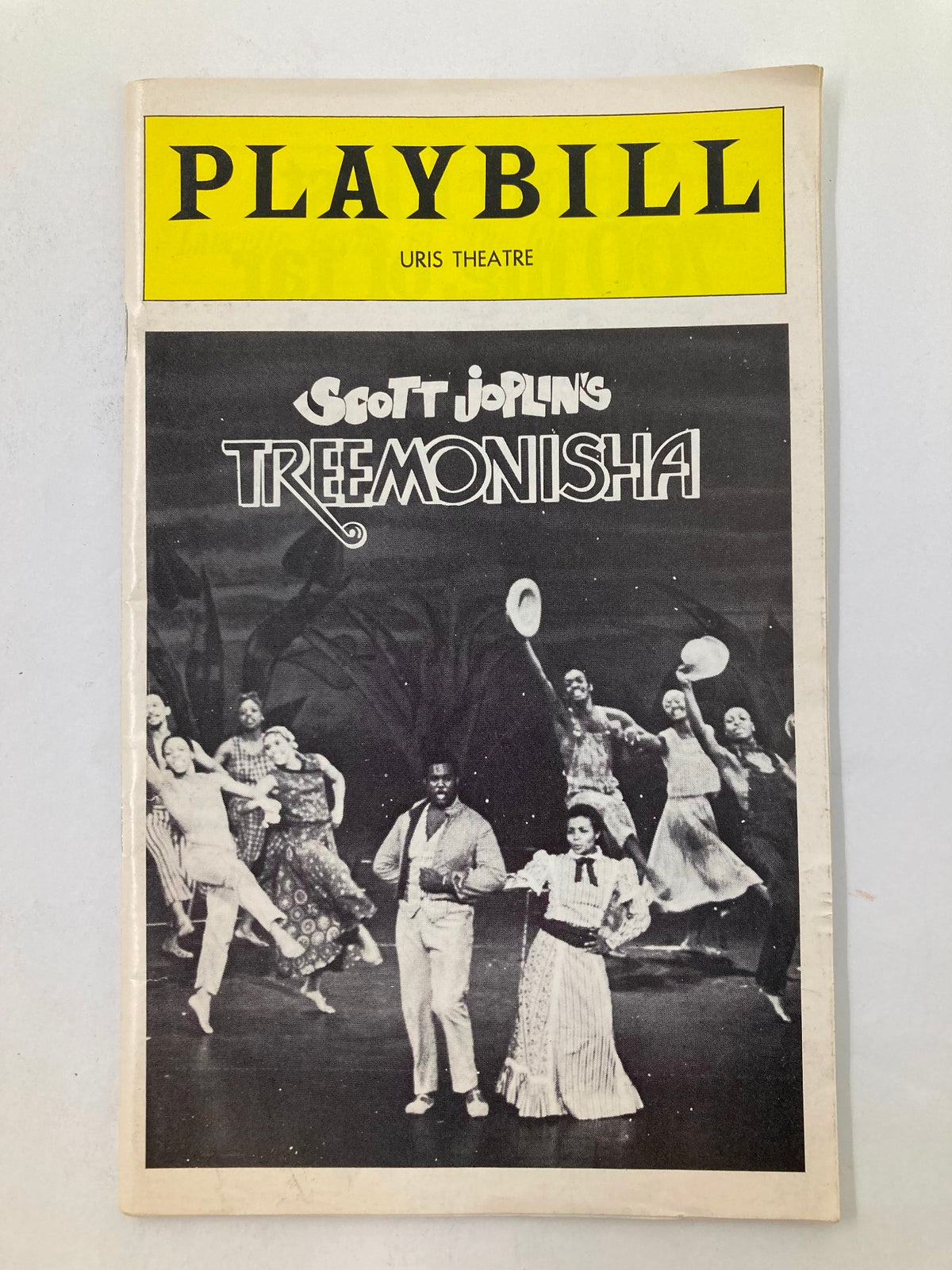 1975 Playbill for Scott Joplin's Treemonisha at the Uris Theatre, featuring a cast performing on stage. This collectible piece highlights the historical significance of the show and its cultural impact.