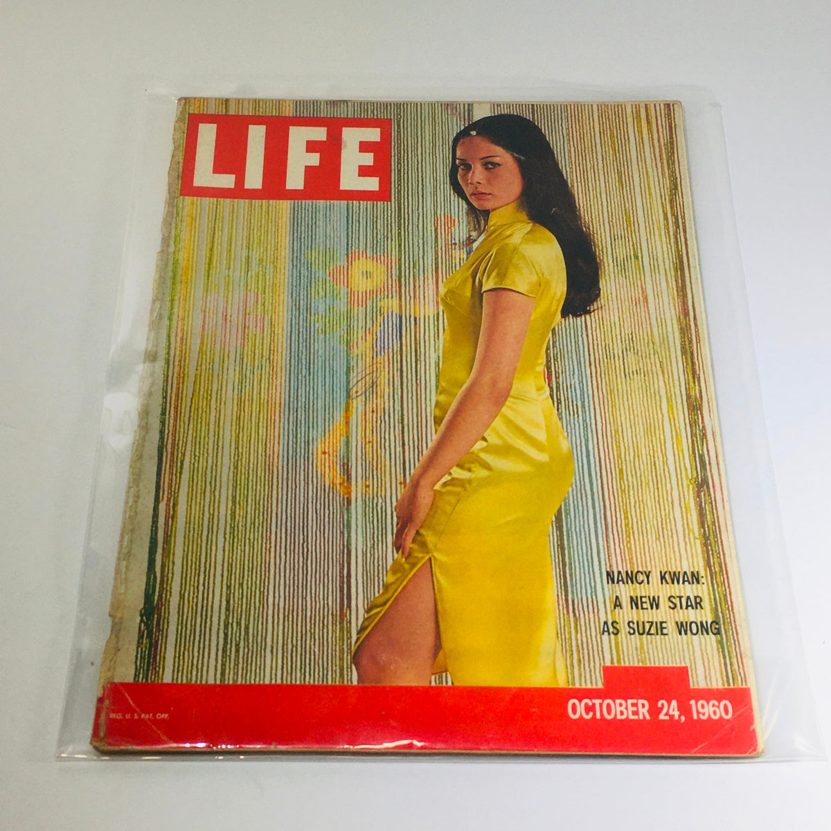 Cover of Life Magazine from October 24, 1960 featuring Nancy Kwan as Suzie Wong wearing a yellow dress, showcasing vintage Hollywood charm.
