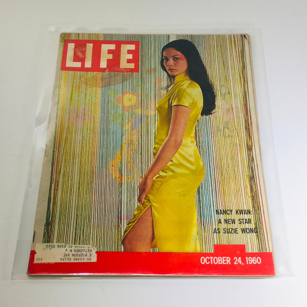 Vintage Life Magazine cover featuring Nancy Kwan as Suzie Wong, dated October 24, 1960, showcasing a striking yellow dress and captivating design.