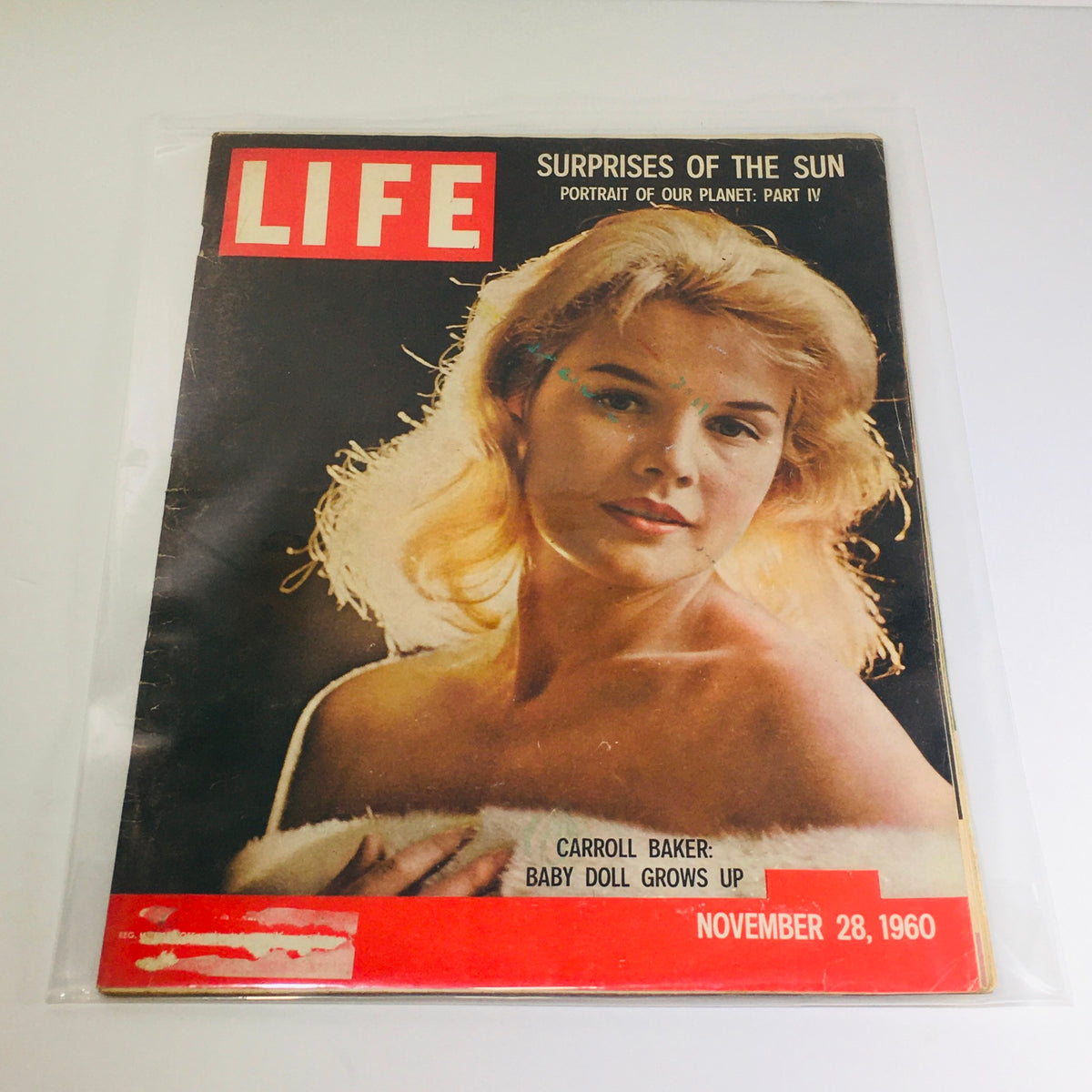 Vintage Life Magazine cover from November 28, 1960 featuring Carroll Baker, highlighting 'Surprises of the Sun' and showcasing the iconic actress in a charming pose.