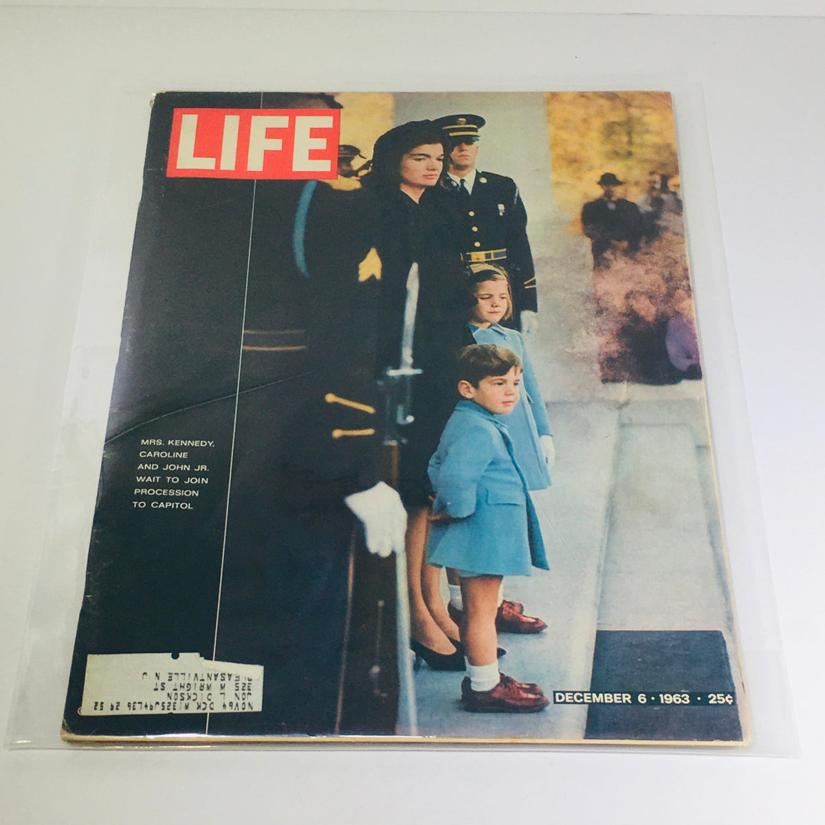 Vintage Life Magazine cover from December 6, 1963 featuring Mrs. Kennedy with her children, Caroline and John Kennedy Jr., wait to join the procession to the Capitol.