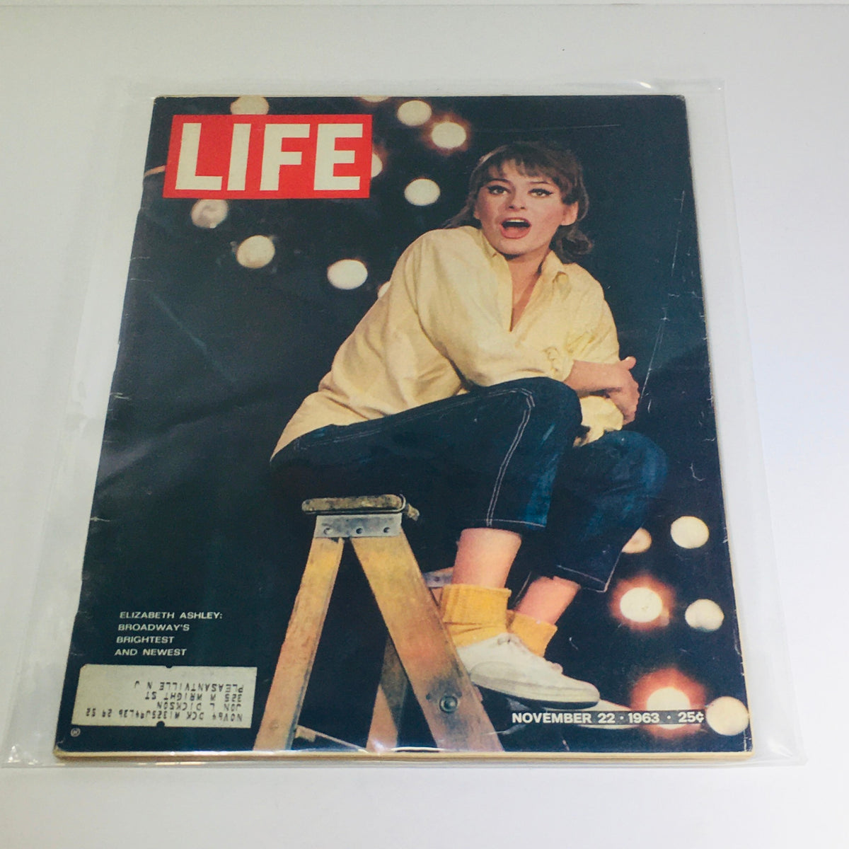 Vintage Life Magazine cover from November 22, 1963, featuring Elizabeth Ashley, Broadway's brightest and newest star, sitting on a ladder against a backdrop of bright lights.