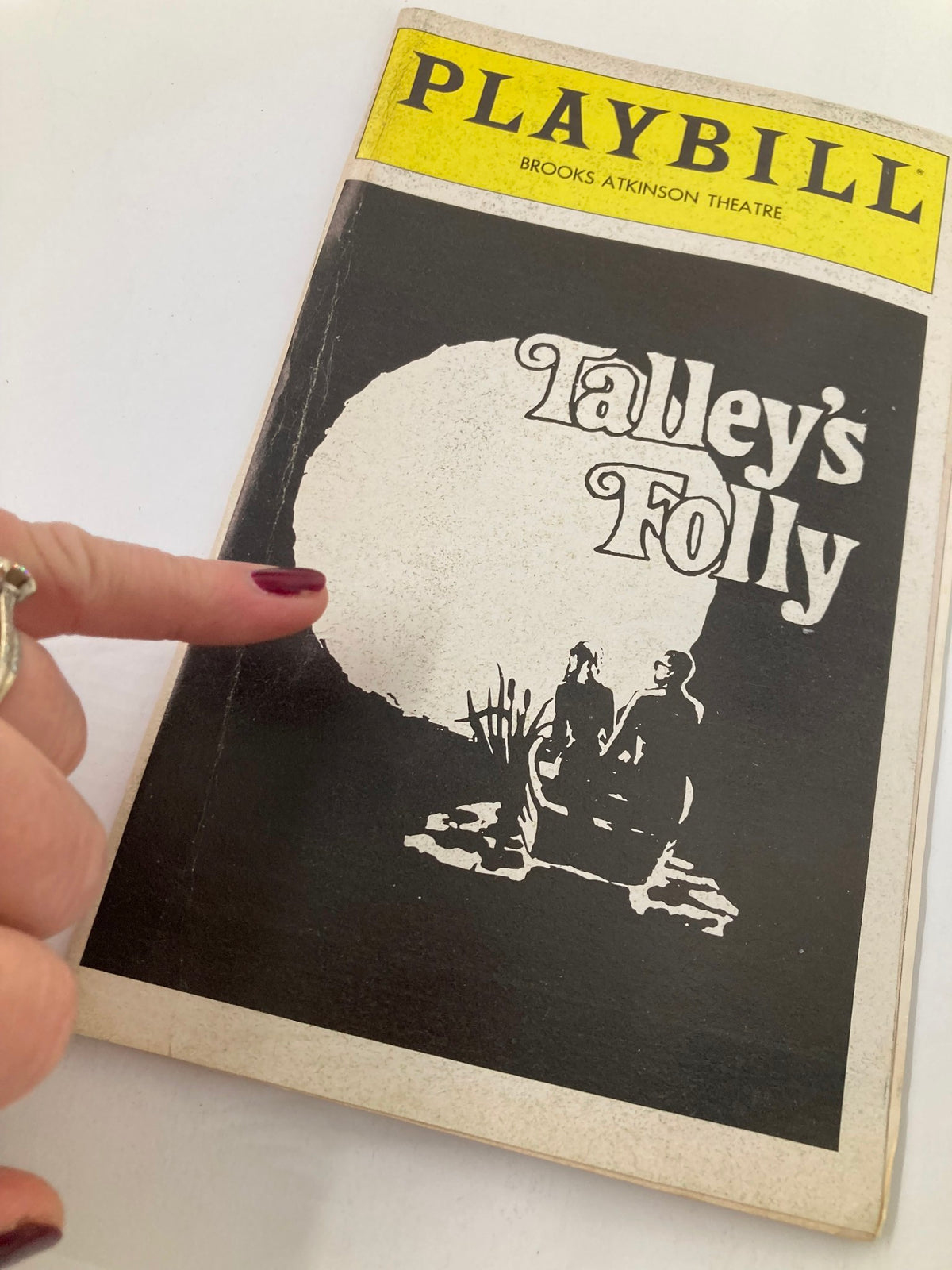 Close-up of the 1980 Playbill for Talley's Folly at Brooks Atkinson Theatre, showing a hand pointing to the cover art.