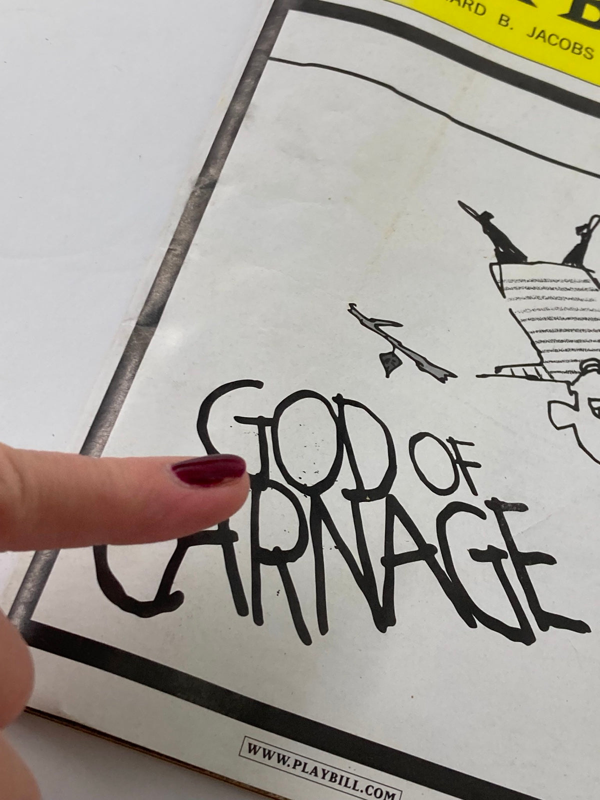 Close-up of the title 'God of Carnage' from the 2009 Playbill at the Bernard B. Jacobs Theatre.