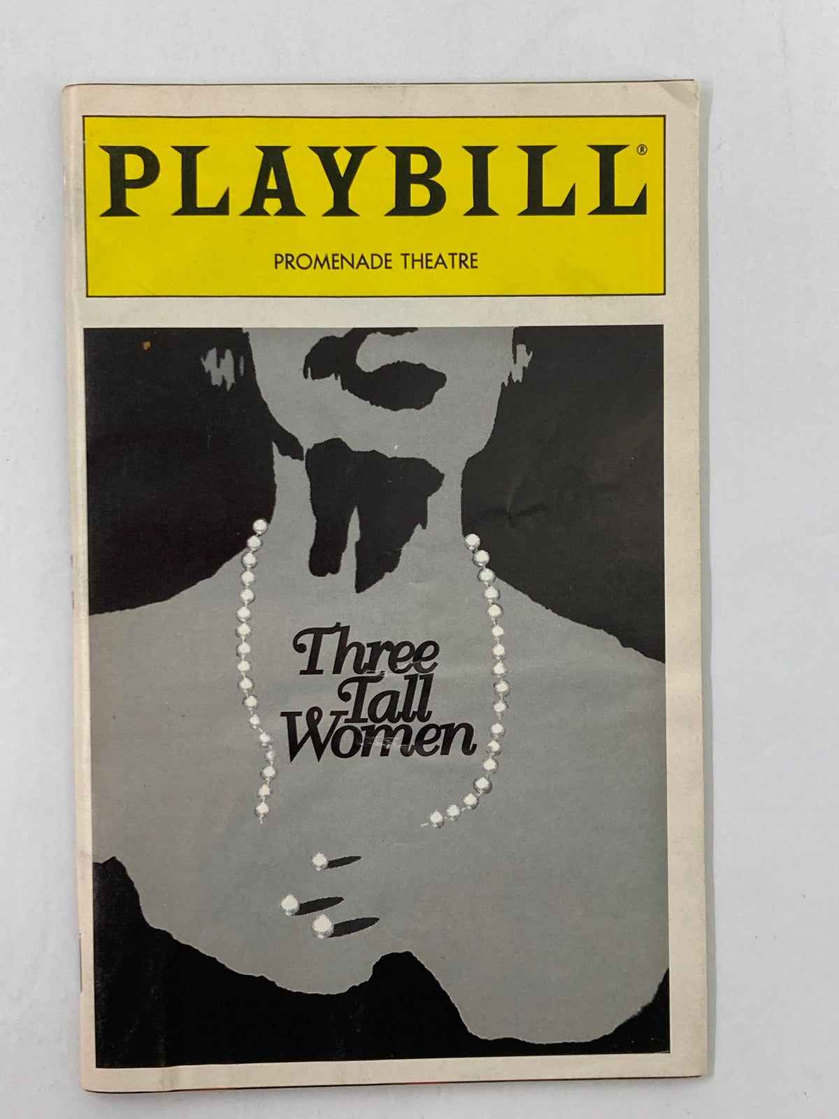 1995 Playbill for Edward Albee's Three Tall Women, featuring a minimalist design with a silhouette and the title prominently displayed.