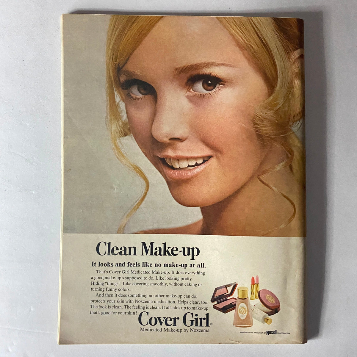 Advertisement for Cover Girl on the back cover of Teen Magazine April 1969, featuring a smiling young woman promoting medicated make-up and skincare.