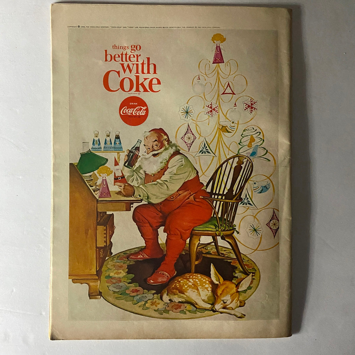 Back cover of American Girl Magazine December 1966 featuring a festive illustration of Santa Claus with a Coke by a Christmas tree, showcasing holiday cheer and nostalgia.