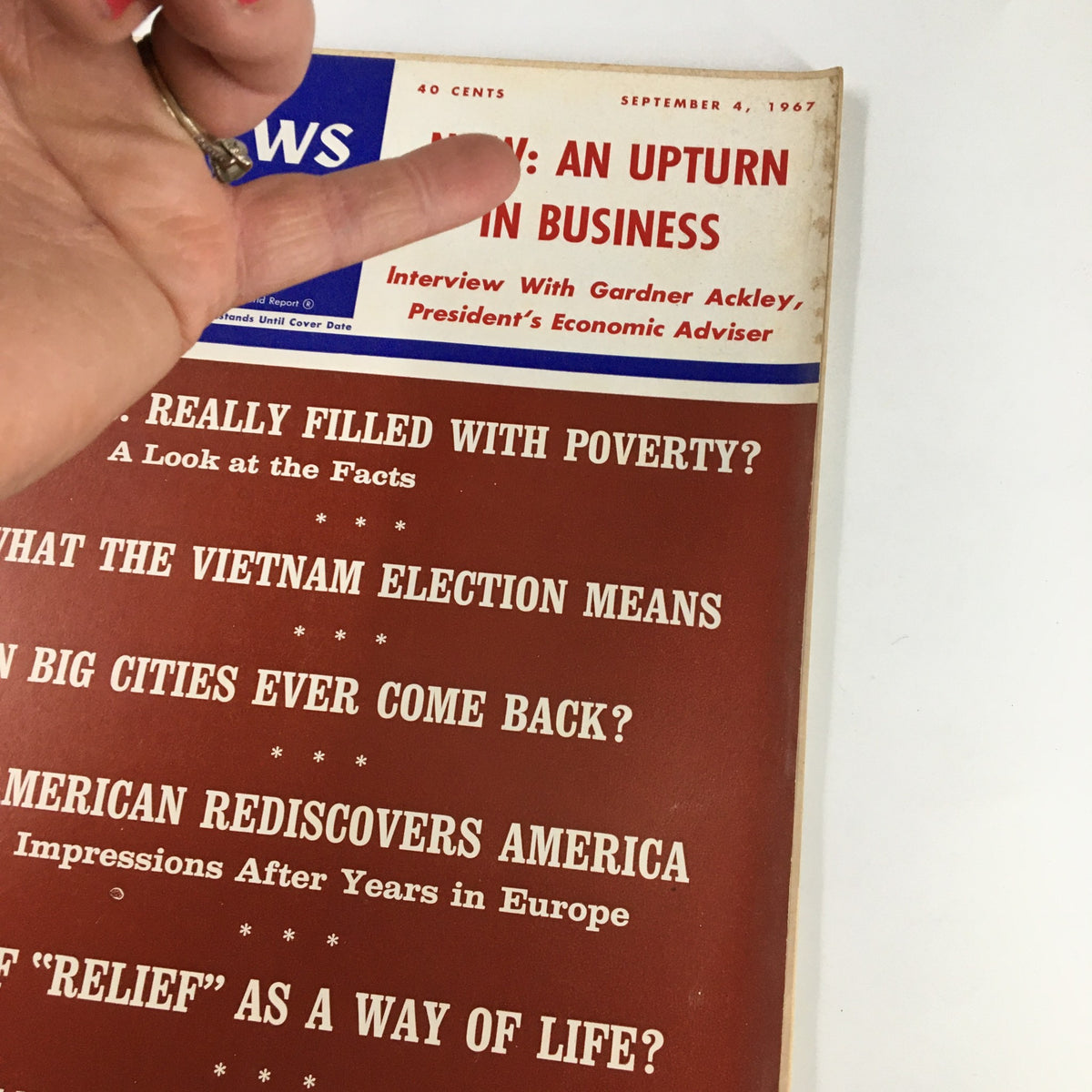 Close-up view of the US News & World Report Magazine cover from September 4, 1967, highlighting the title 'Now: An Upturn in Business' along with key article topics related to poverty, elections, and urban recovery.