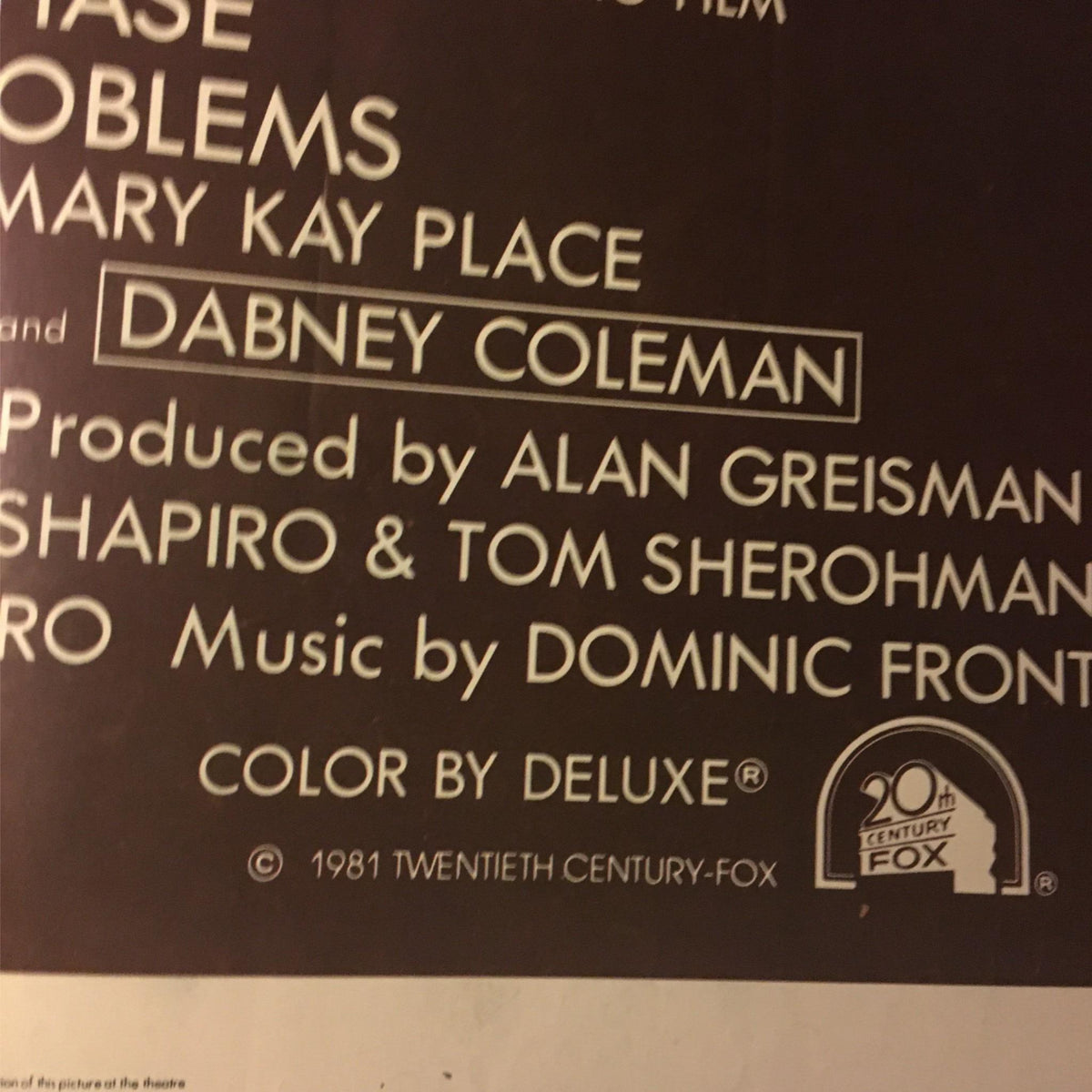 Detailed view of production credits from the 1981 Modern Problems movie poster featuring Chevy Chase and Dabney Coleman.