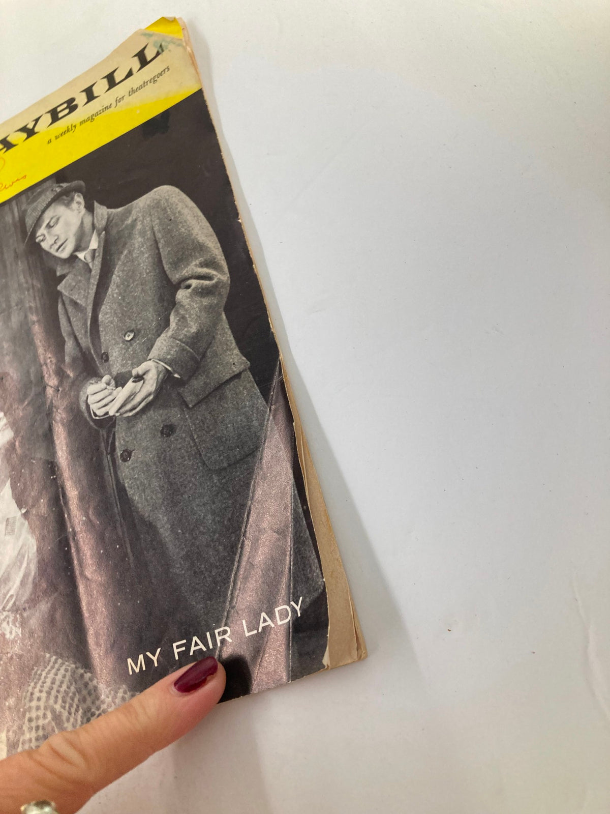 Side view of the 1959 Playbill for My Fair Lady, showing the title clearly alongside signs of aging such as folds and creases.