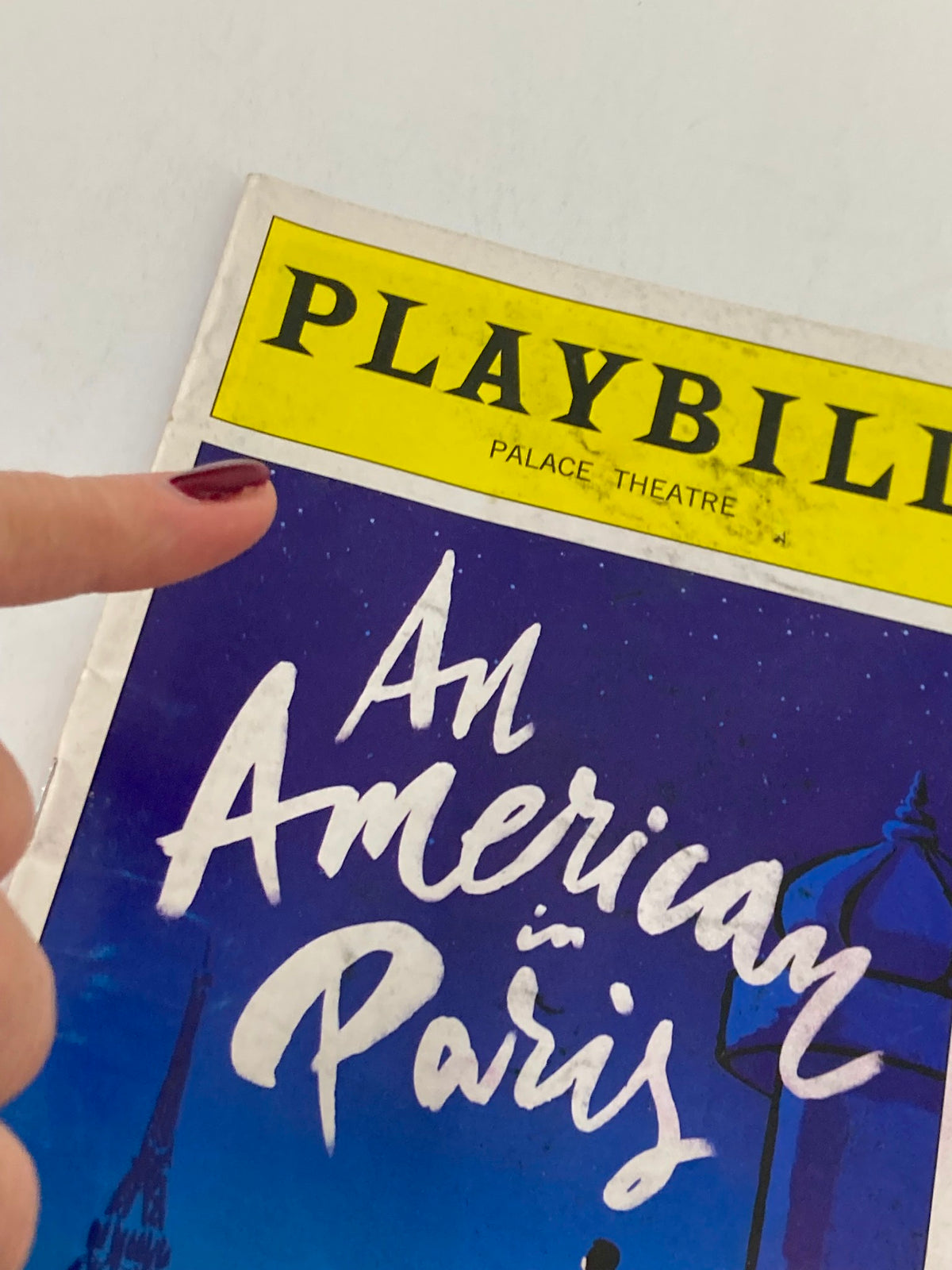 Close-up view of the 2015 Playbill for An American in Paris, highlighting the title and Palace Theatre logo.