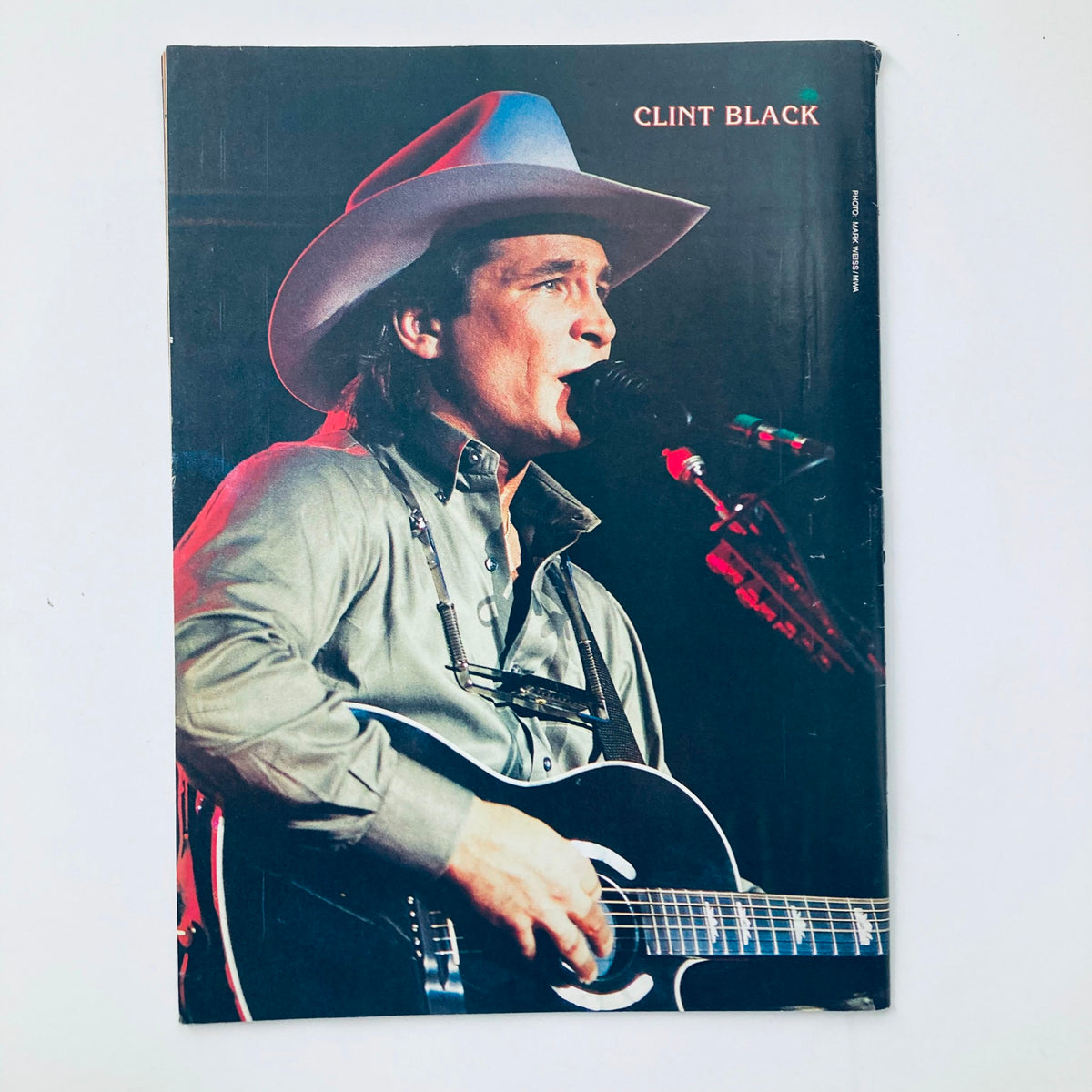 Cover page featuring Clint Black on the Country Song Roundup Magazine from January 1992. The image showcases the artist performing on stage, highlighting the vibrant energy of country music during this era.