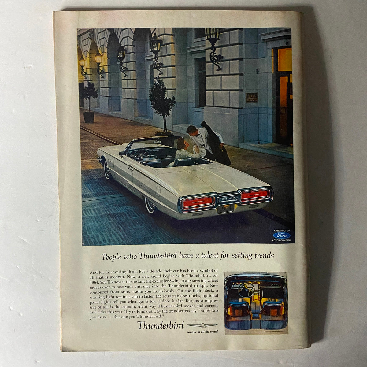 Advertisement for Ford Thunderbird in vintage style, showcased in a luxurious setting with a classic car and elegant attire, highlighting the car's features and appeal from the 1960s.