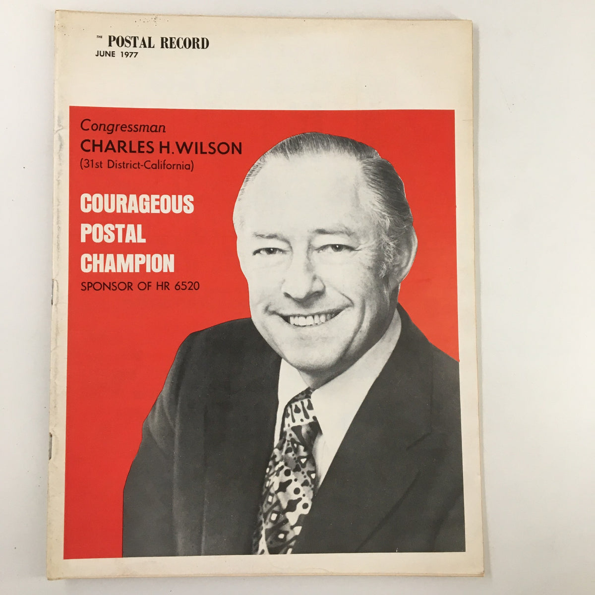 The Postal Record Magazine June 1977 featuring Congressman Charles H. Wilson, showcasing his profile as 'Courageous Postal Champion.' The cover highlights his support for HR 6520 with a vibrant design, making it a significant collectible.