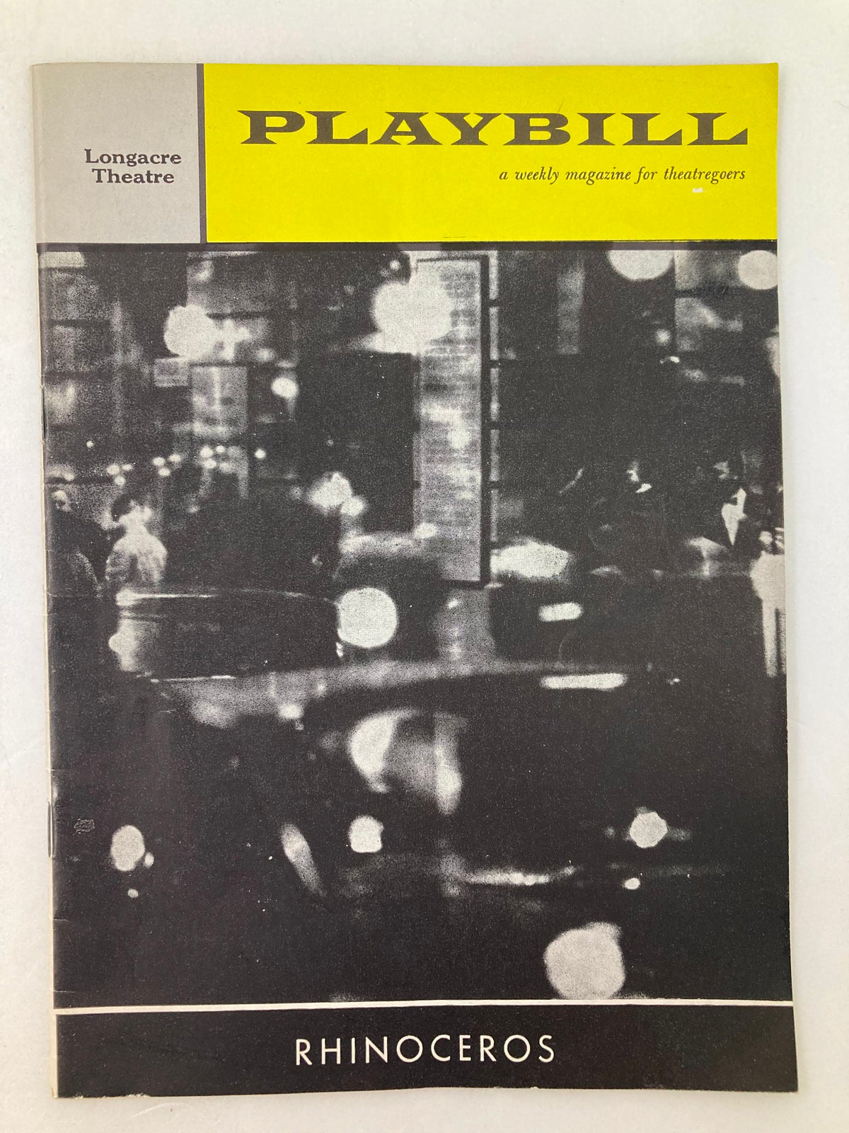 1961 Playbill for Rhinoceros at Longacre Theatre featuring a black and white cover image of a city street scene.