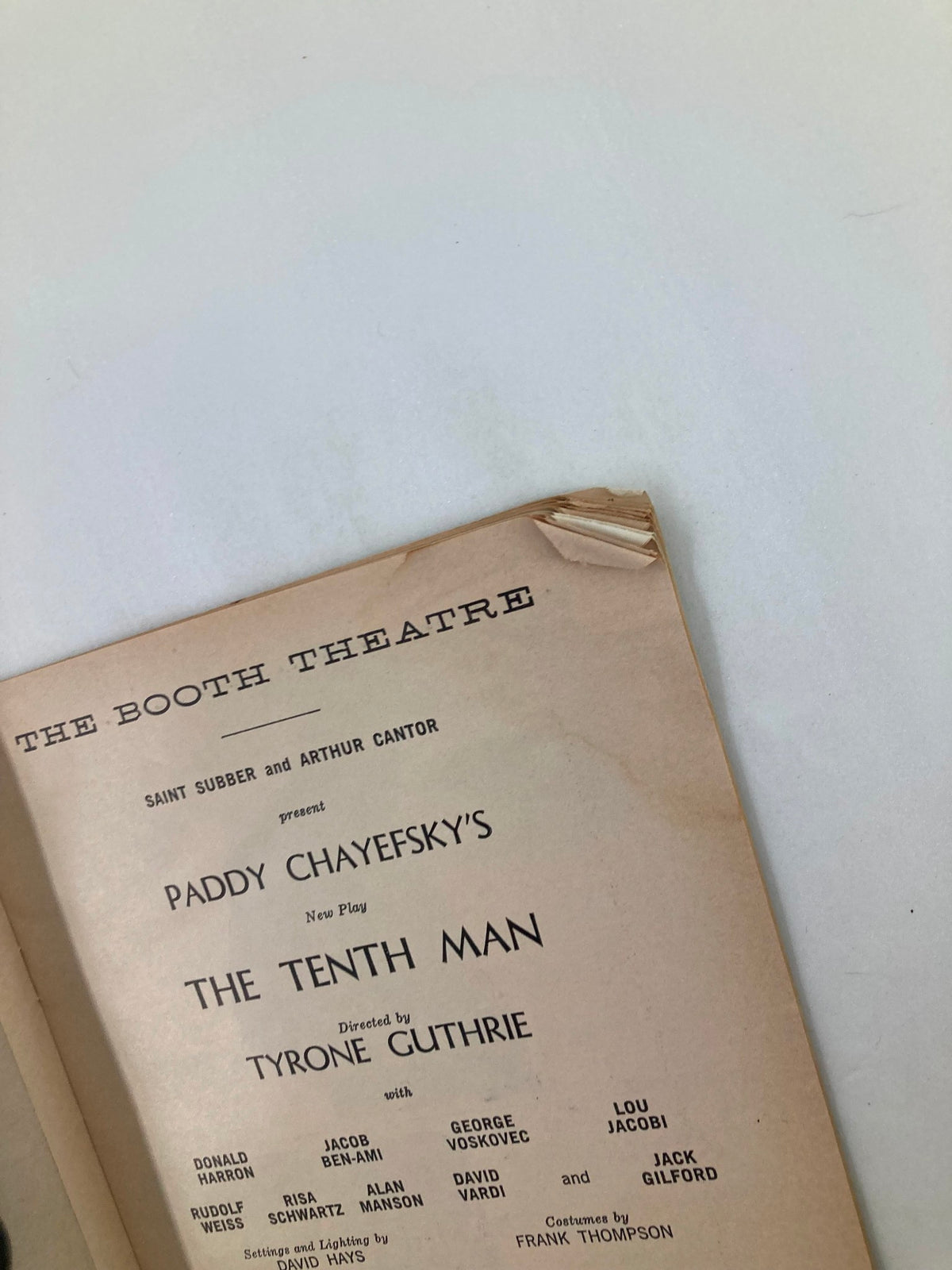 Another inside page from the 1961 Playbill for The Booth Theatre, displaying production information for The Tenth Man by Paddy Chayefsky, including director and cast credits with minor wear shown.