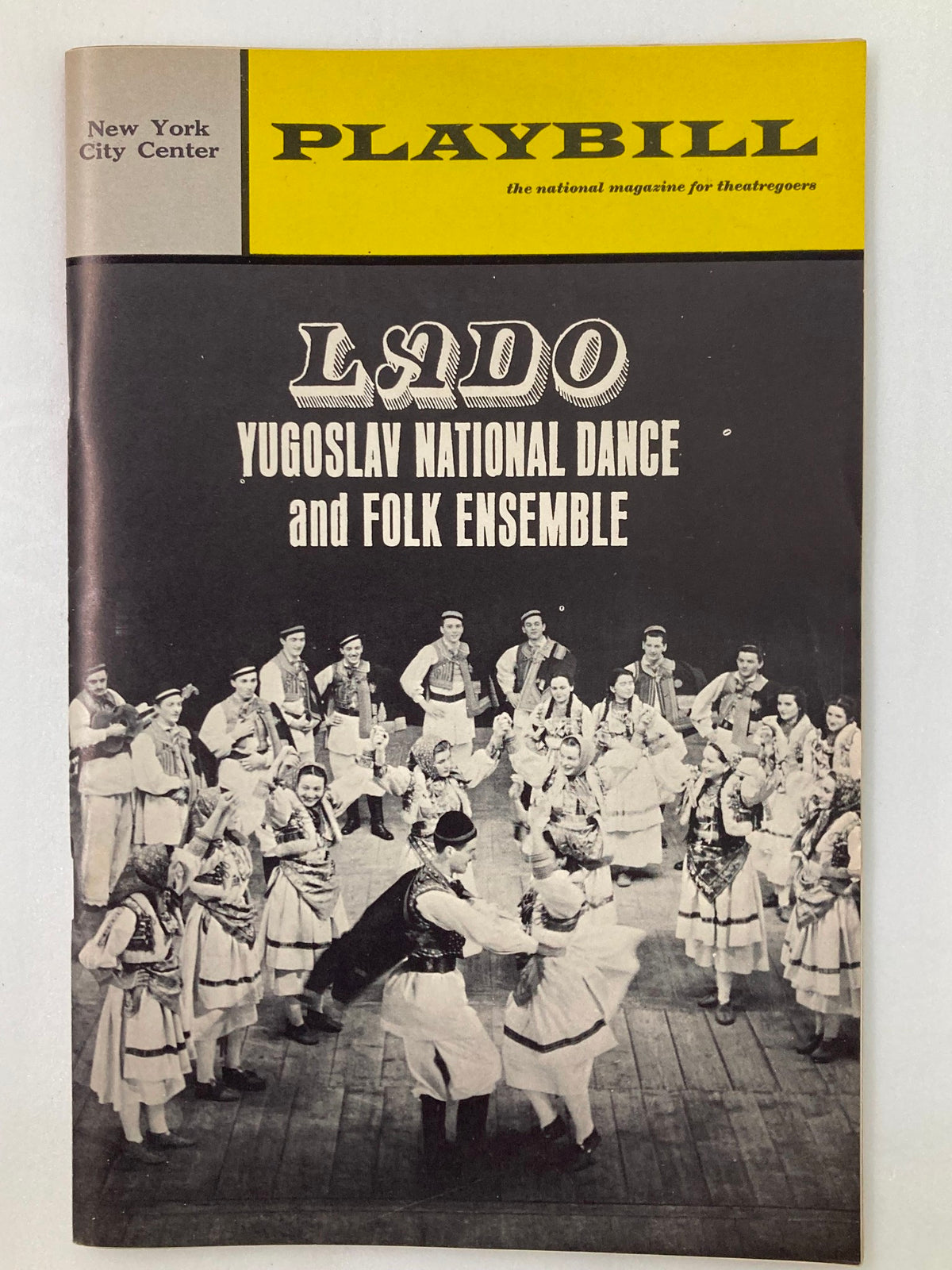 1967 Playbill from New York City Center featuring the Lado Yugoslav National Dance and Folk Ensemble, showcasing a traditional folk dance performance with a vibrant group of dancers in traditional attire.