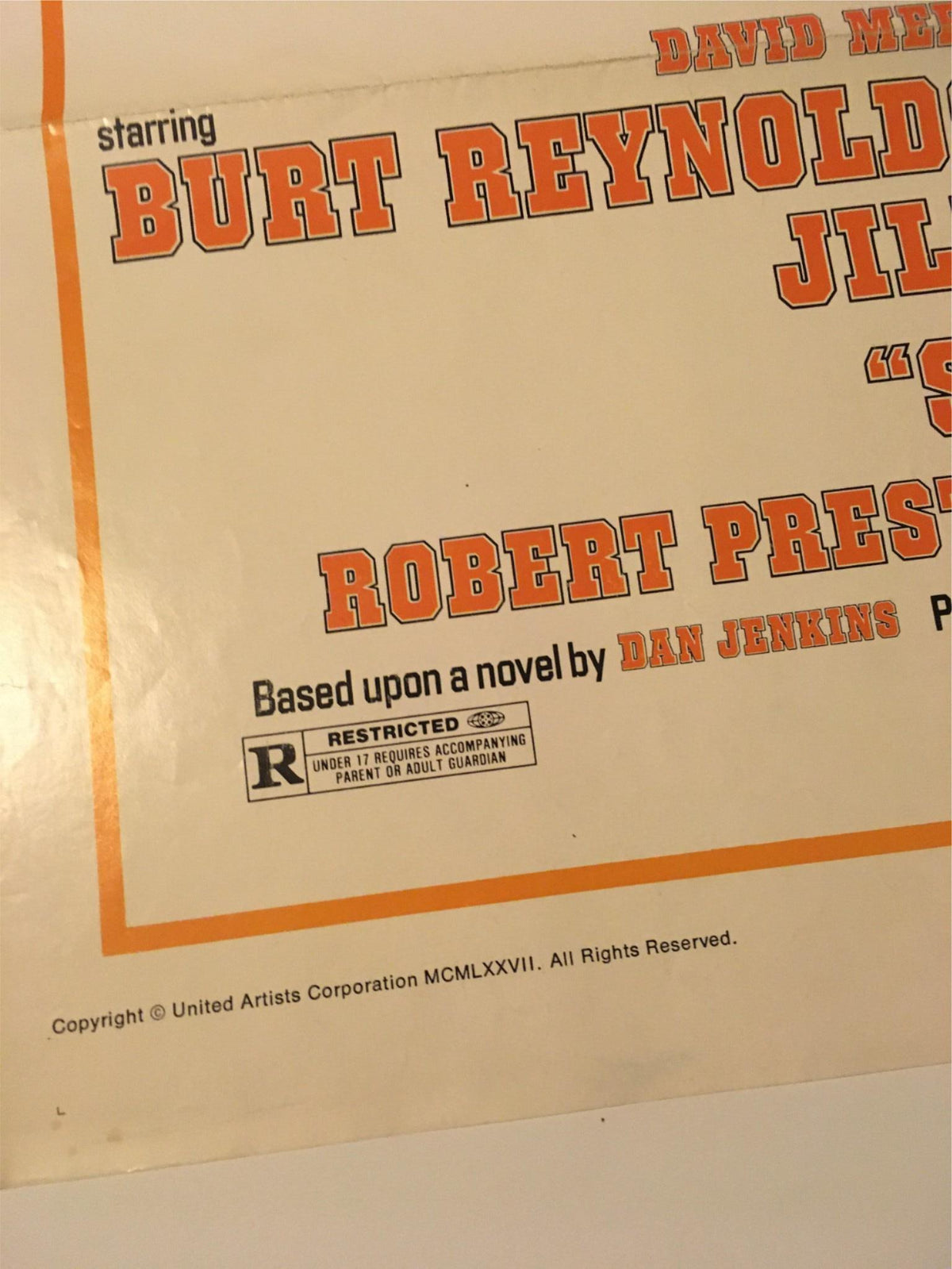 Close-up of the 1977 Semi-Tough movie poster featuring Burt Reynolds, showcasing actor credits and original film details.