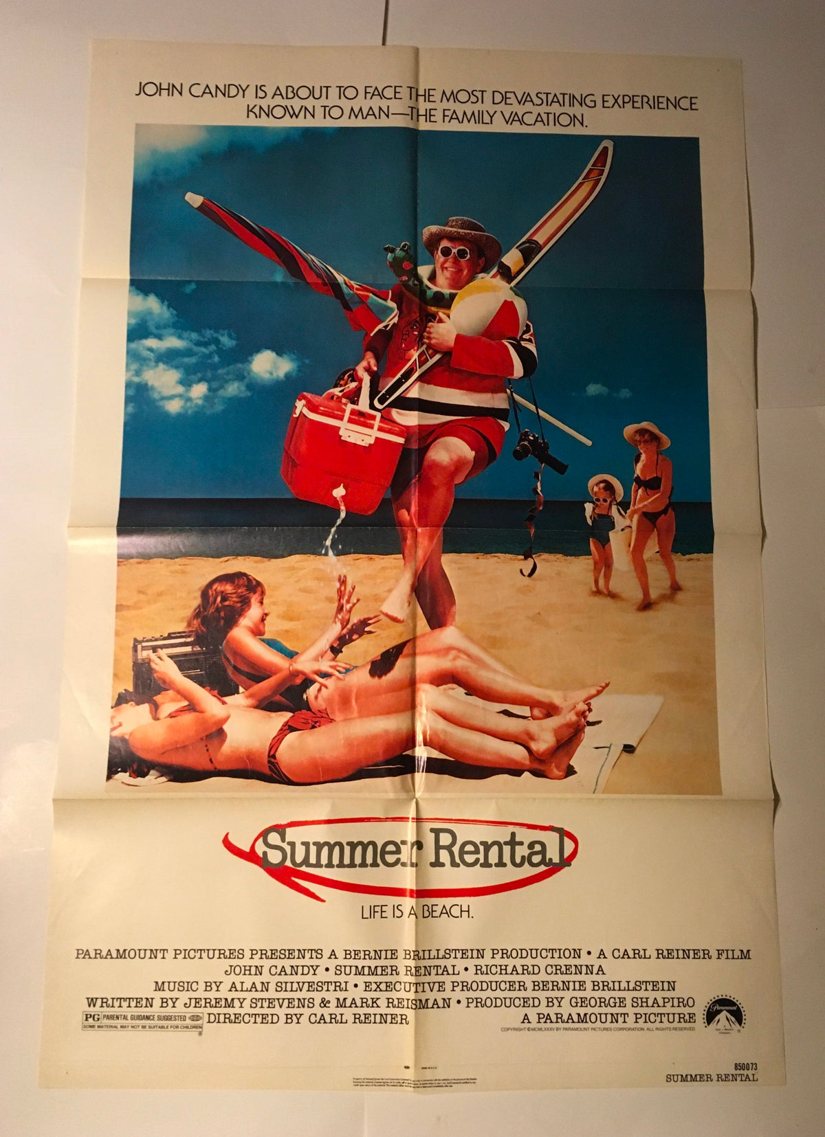 1985 Summer Rental 41" x 27" Original Movie Poster displaying John Candy in a beach scene with a surfboard, capturing the essence of a family vacation.