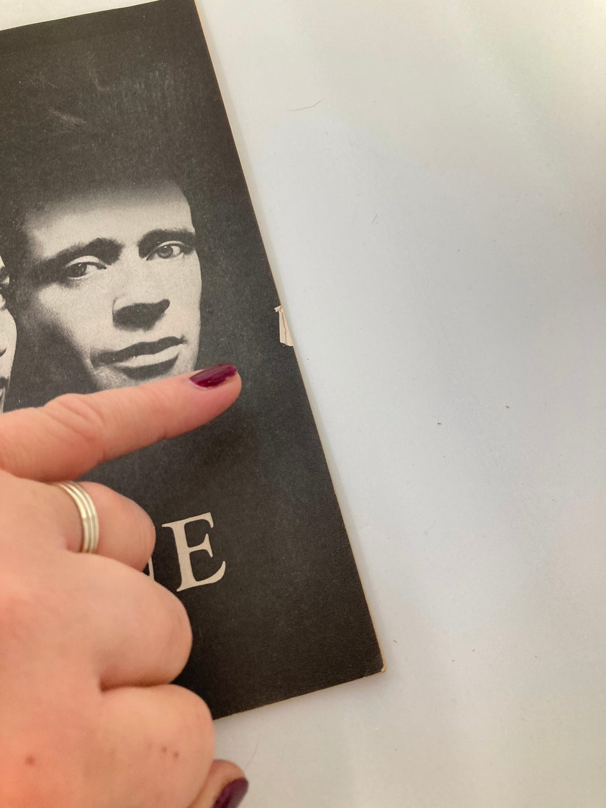 Close-up view of the 1954 Playbill for Ondine, highlighting Mel Ferrer's face and a slight damage on the cover, a piece from the original production at the 46th Street Theatre.