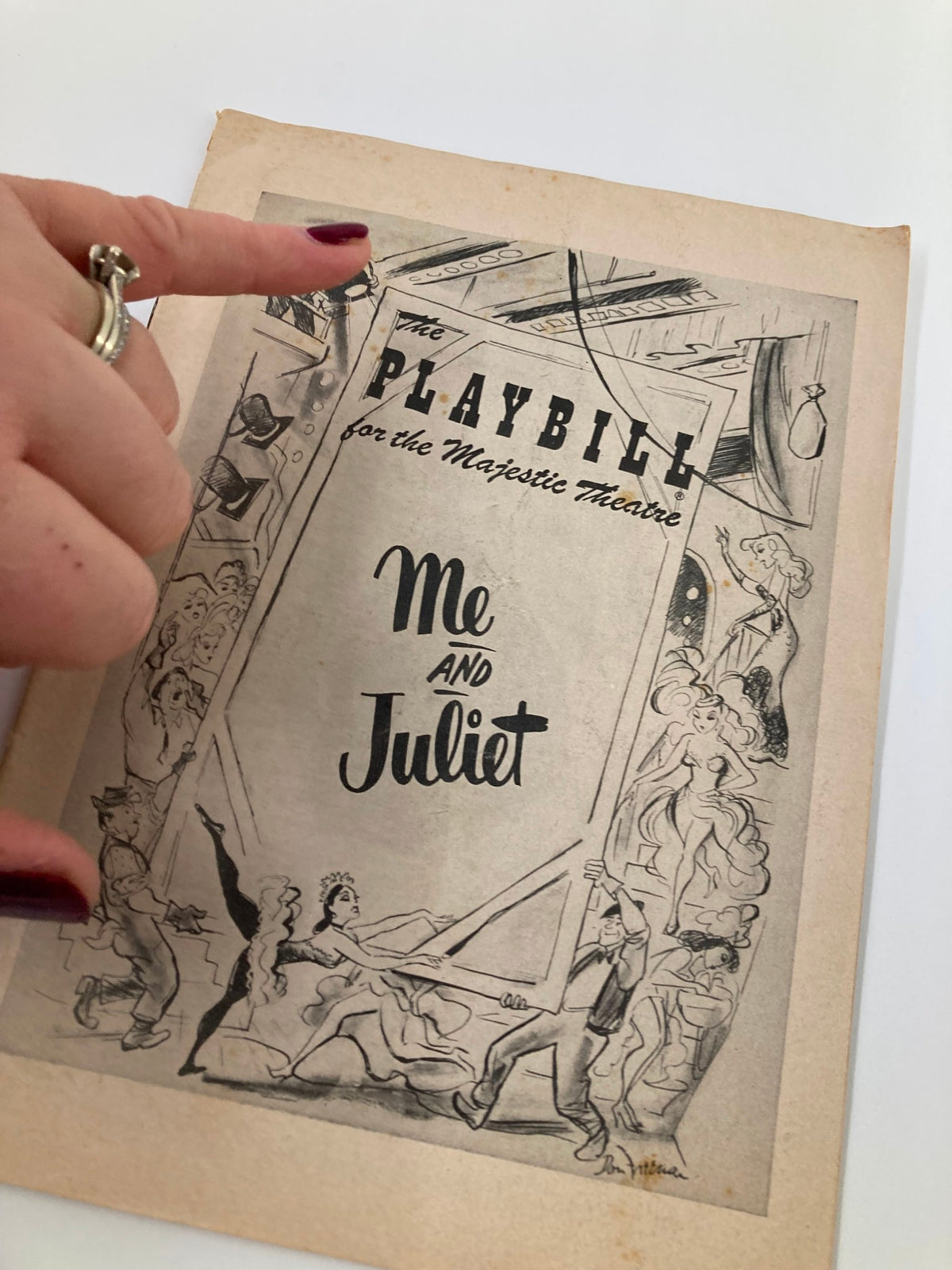 Close-up of the 1953 Playbill for 'Me and Juliet' at the Majestic Theatre, highlighting the cover art and theatrical elements.