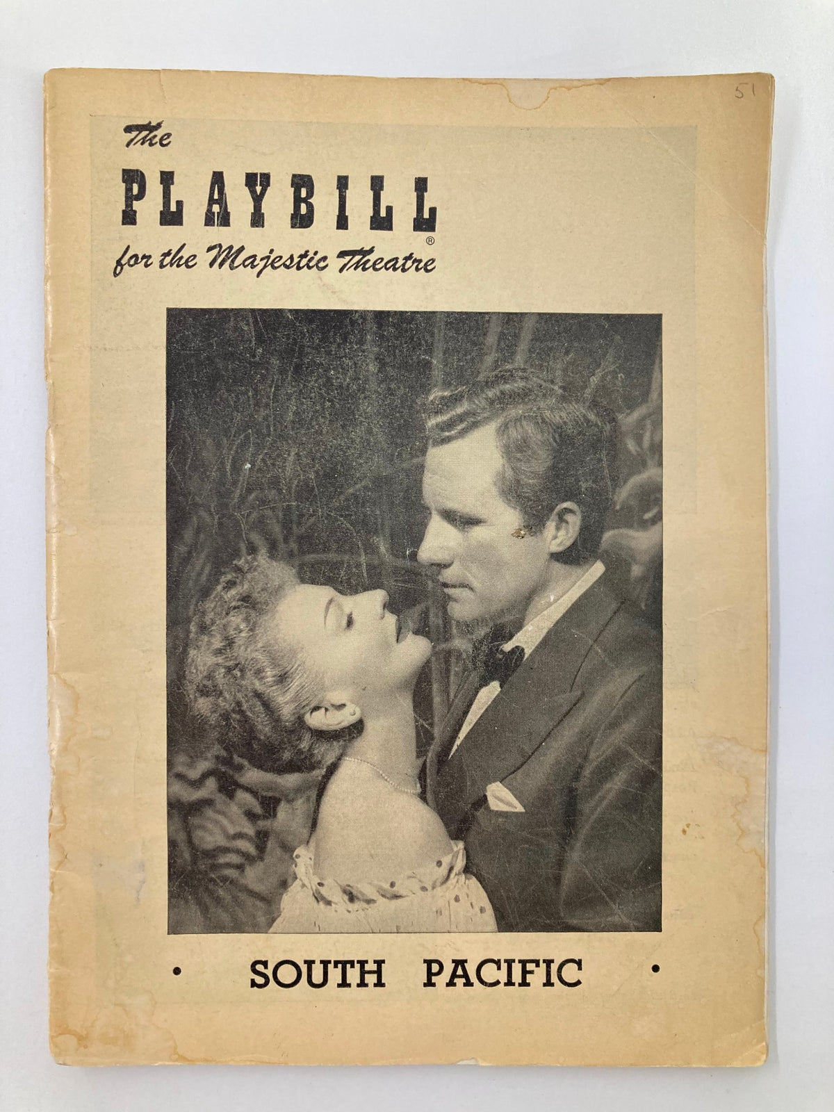 1950 Playbill for the Majestic Theatre showcasing the musical South Pacific featuring a captivating black and white image of the lead characters Mary Martin and Ray Middleton.