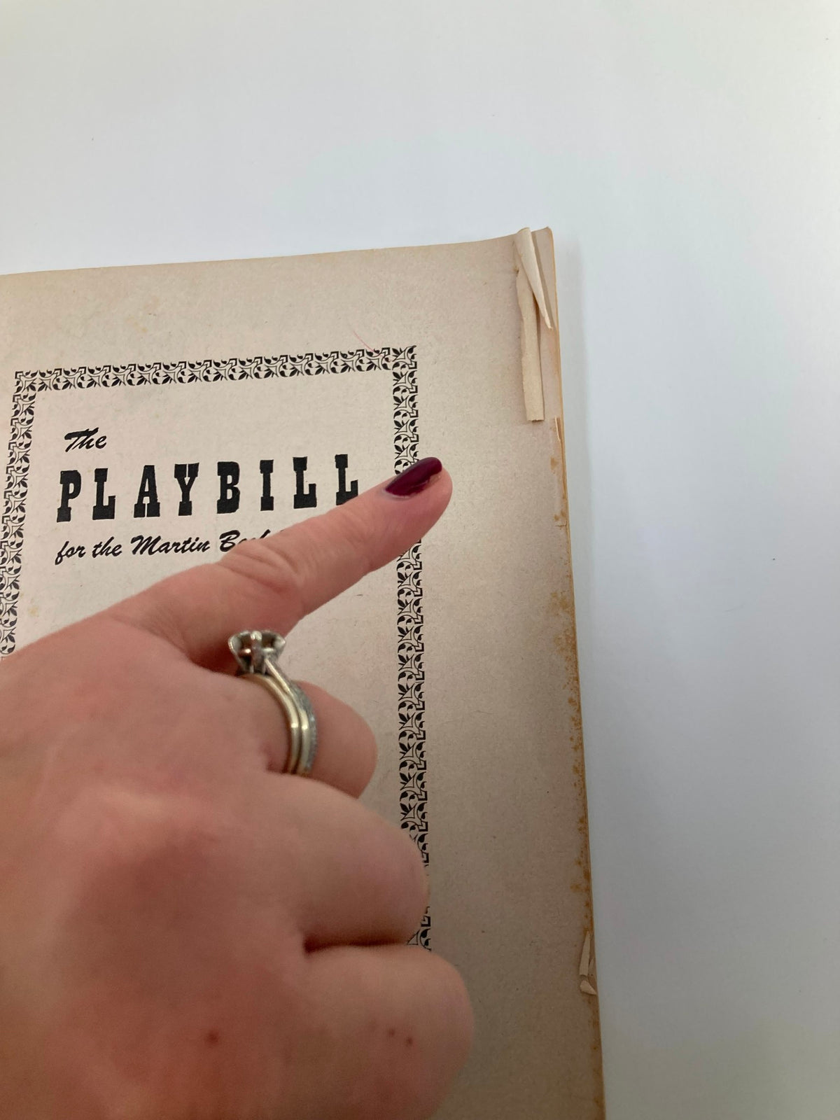 Close-up view of the 1953 Playbill for The Crucible at the Martin Beck Theatre, highlighting the cover details and worn edges.