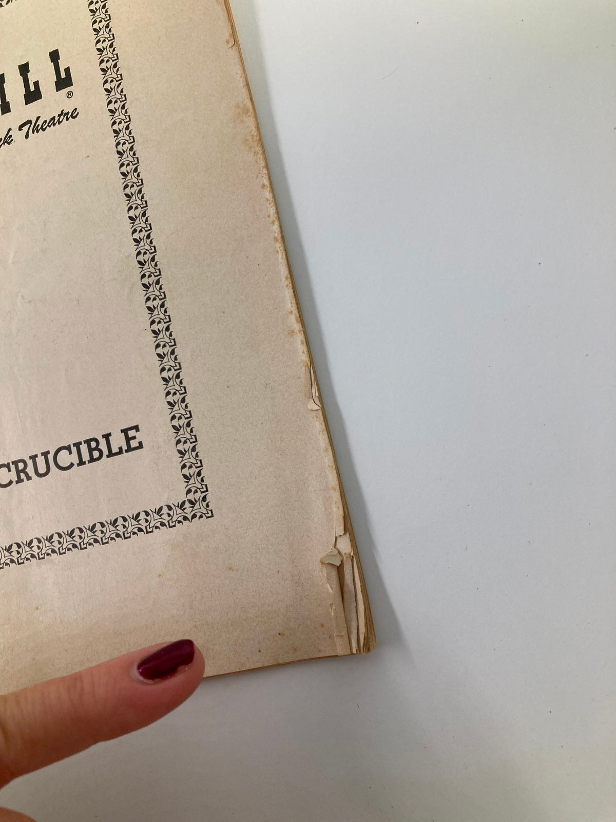 Side angle of the 1953 Playbill for The Crucible at the Martin Beck Theatre, focusing on the worn edges and cover texture.